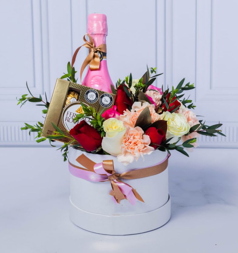 Ilusion Gift Box  - Box of Assorted Flowers like Roses and Carnations with Accents of Eucalyptus. INCLUDES: BAREFOOT PINK MOSCATO ROSE WINE AND A FERRERO ROCHER BOX OF CHOCOLATES.  Bouquet will be delivered approximately as pictured. **** Flower color may vary depending on availability ***