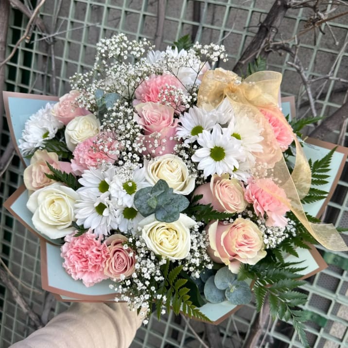 Daisy About You  - White and Pink Wrapped Bouquet Full of Daisies, Roses and Pink Carnations with accents of Baby Breath and Eucalyptus. ***Paper and flower color may vary depending on availability****