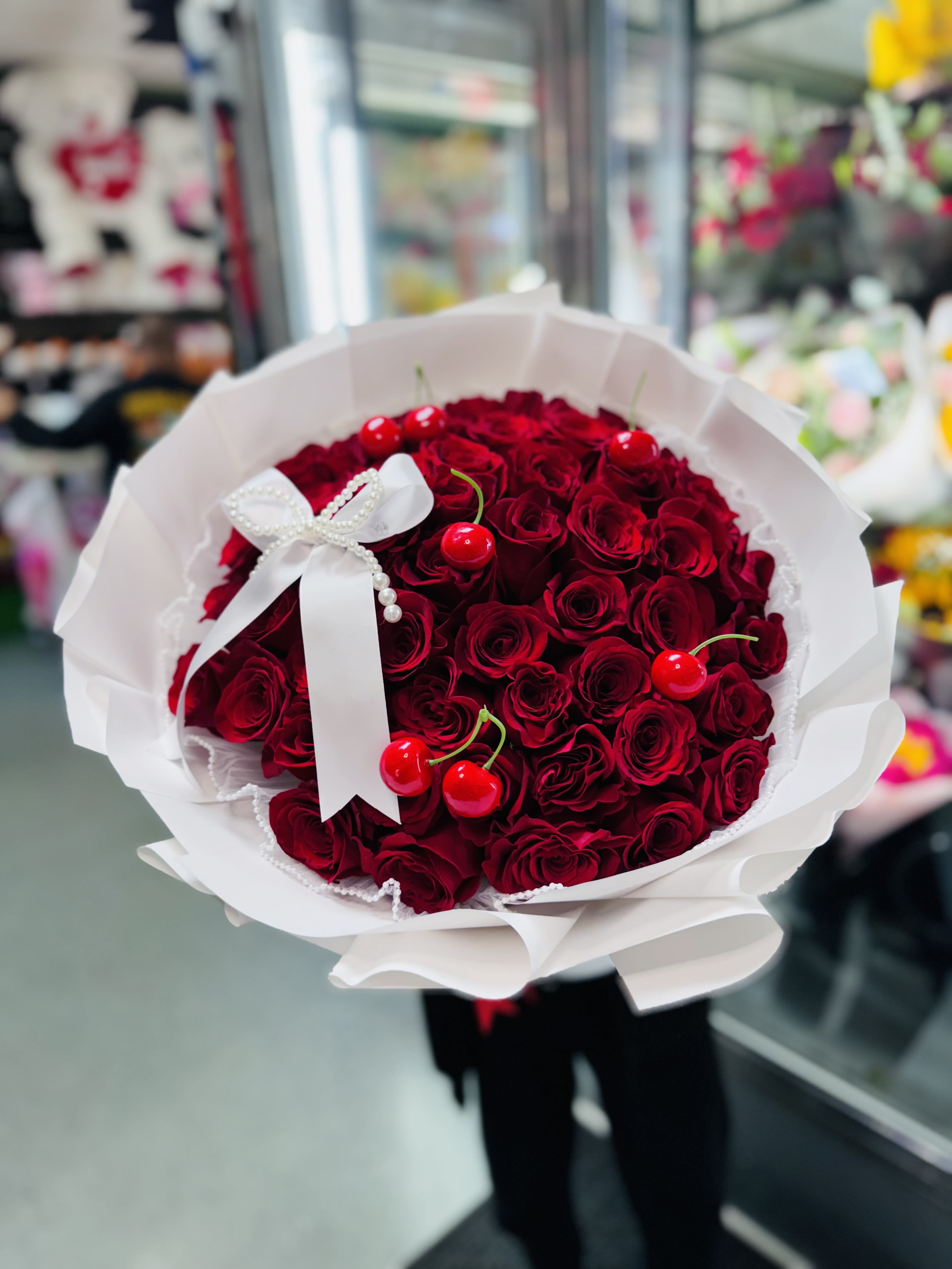 Buchon Cherry - White Wrapping paper 50 Roses. Plastic Cherries  White Bow to finish it off!