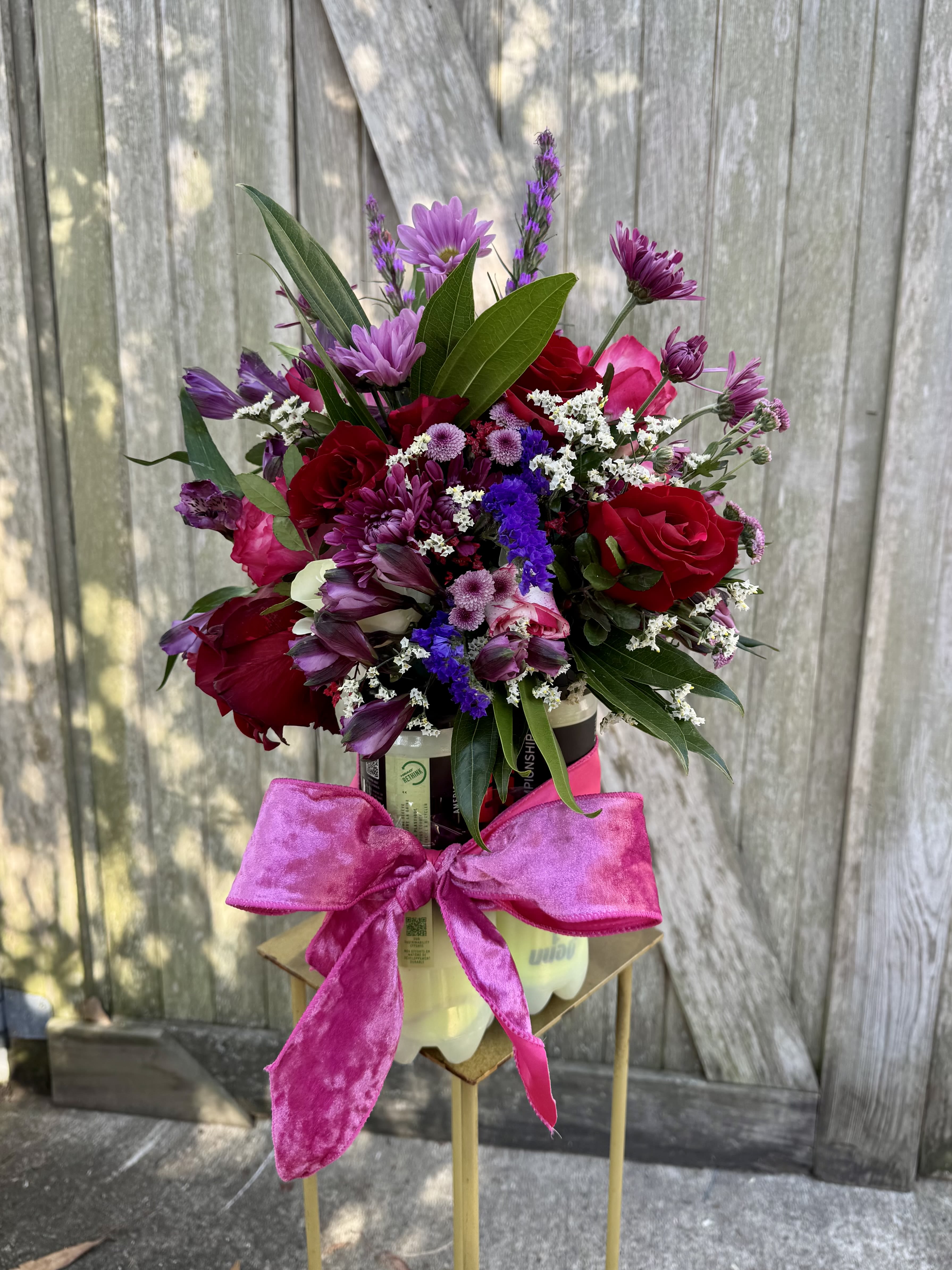 A Perfect Match - Three tubes of tennis balls topped with a fresh floral arrangement—playful, unexpected, and full of charm. Designed for the tennis-loving, flower-adoring gals &amp; guys in your life, this arrangement truly is a perfect match. Florals and colors vary based on seasonal availability. Love, served! 