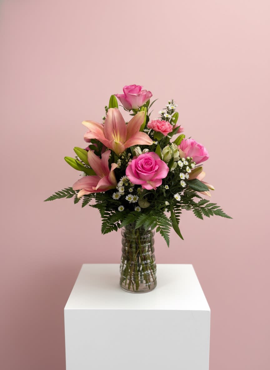 Simply Sweet Vase - A fresh mix of lilies and roses with soft filler and greenery, arranged in a clear glass vase. Light, cheerful, and perfect for any occasion.
