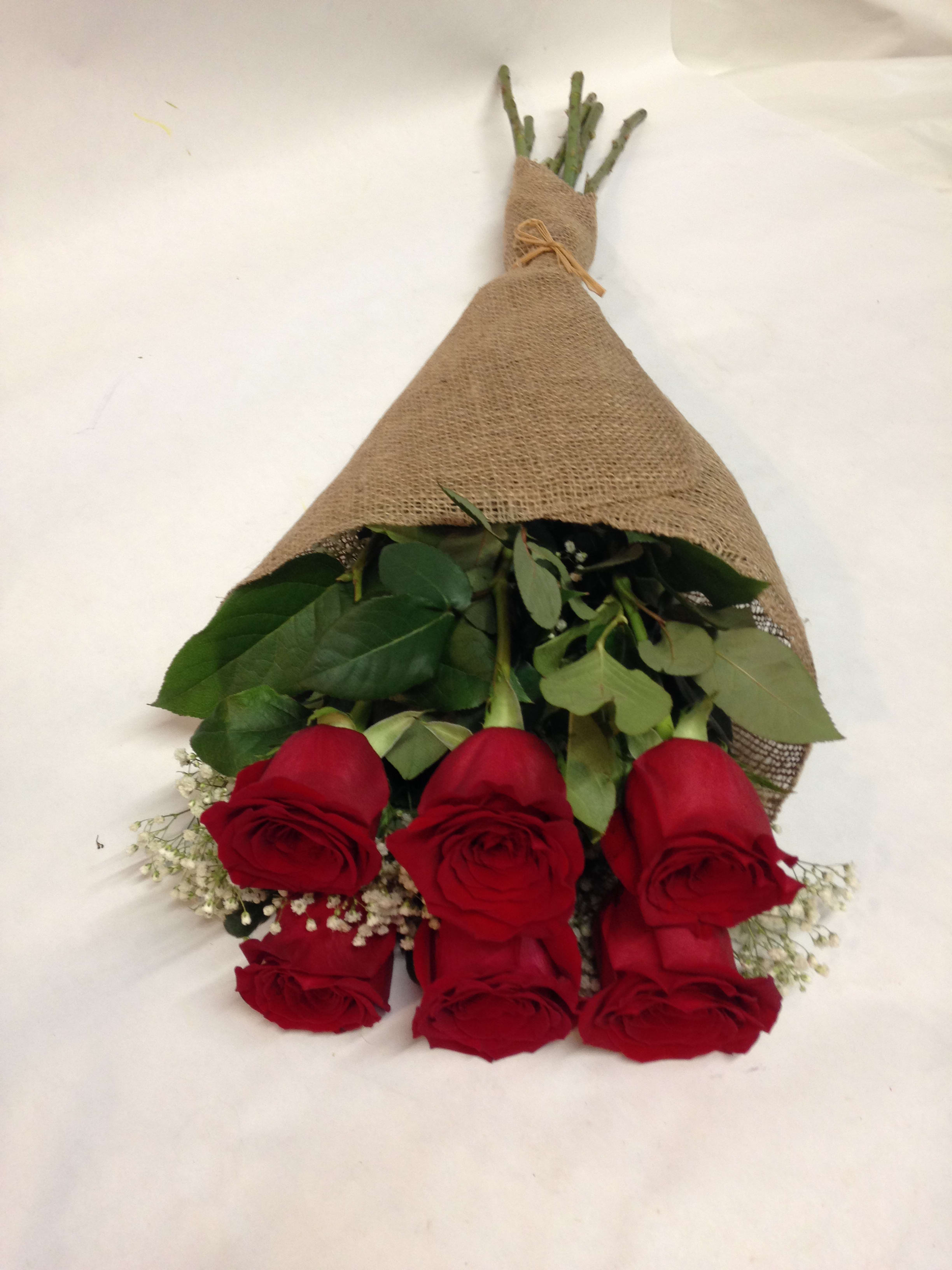 Half A Dozen Roses in a Burlap Wrap - 6 long premium stem roses paired with baby's breath in burlap wrap  WE also offer: peach, pink, white, orange, lavender and hot pink.      (Some flowers may be subject to change depending on the season. We will contact you with available flower substitutions; please contact us with specific questions if you are concerned with flower availability, thanks!)  Featured arrangement: $69.75 - 6 roses (Regular Price).  $129.75 - 12 roses (Deluxe Price).   $229.75 - 24 roses (Premium Price).
