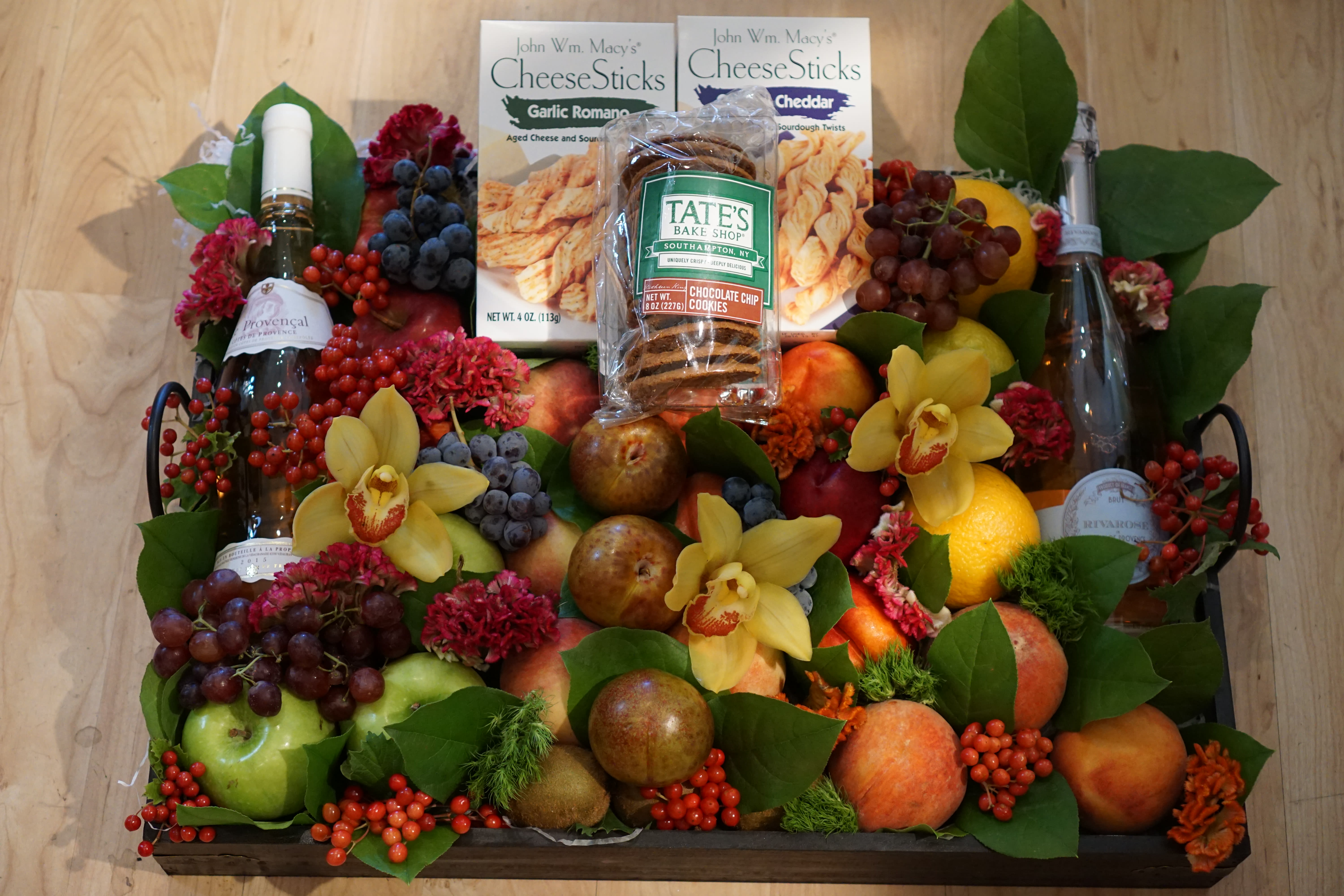 Wine &amp; Gourmet Fruit Basket - A beautifully designed wooden tray with fresh fruit, gourmet food items, and two bottles of champagne