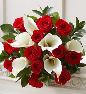 Mini Calla Lily - Mini Calla Lily white and red roses surrounded by leaves in a vase 
