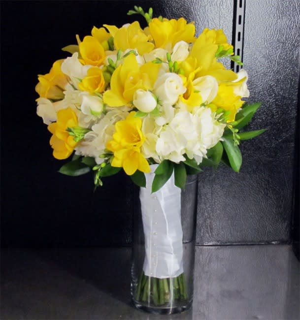 Evan Bridal Bouquet - This premium bridal bouquet features White Hydrangeas, White Spray Roses, Yellow Cymbidium Orchids and Yellow Freesias. All of our wedding bouquets are custom and we can customize them to match your colors for a wedding any time of the year.  Deluxe package includes Bridal and Toss Bouquet  Contact us online or call us at 619-237-8842 to discuss color options or to schedule a complimentary wedding consultation with one of our wedding designers.