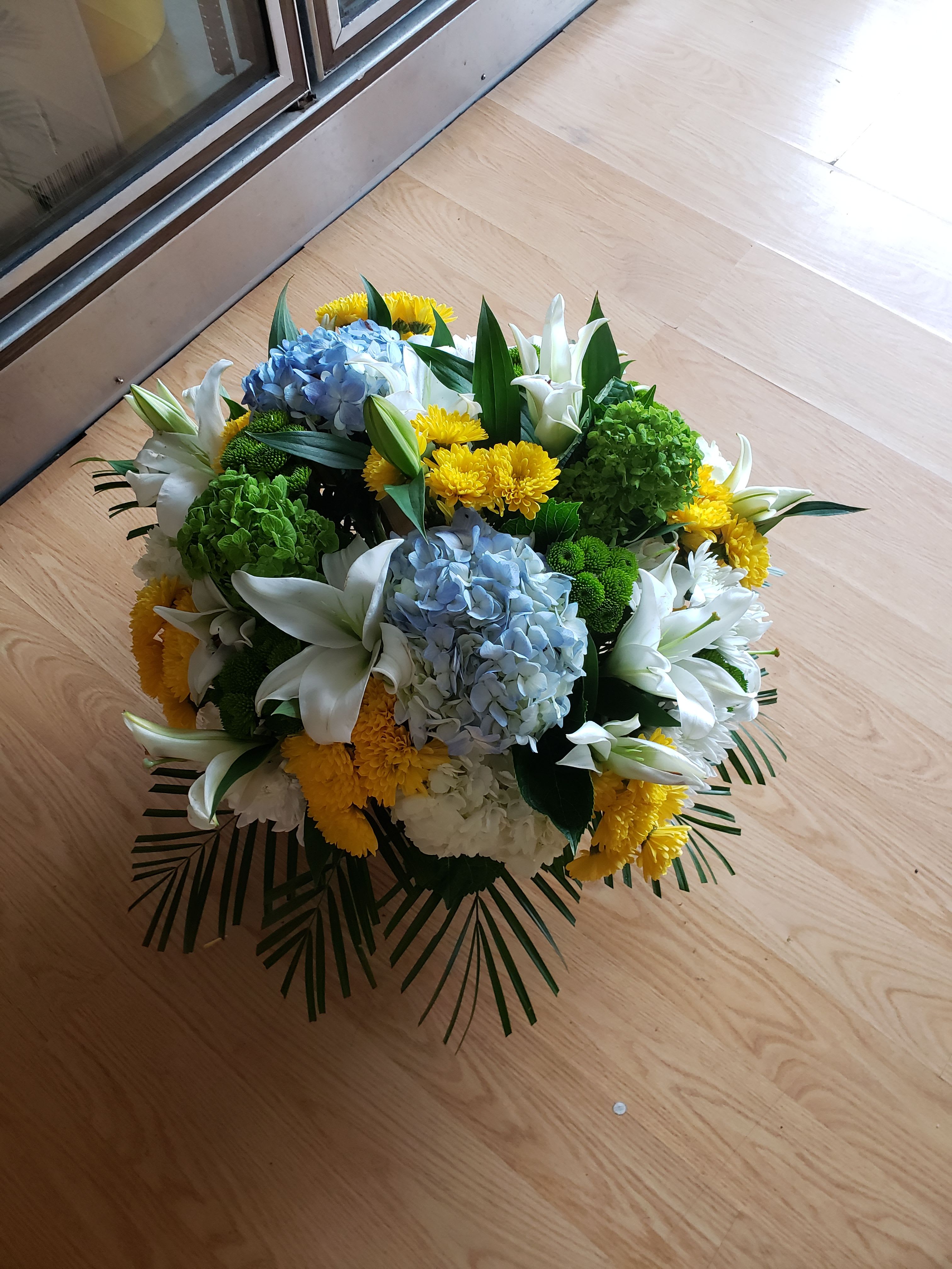 traditional centerpiece - yellow roses and blue hydrangeas