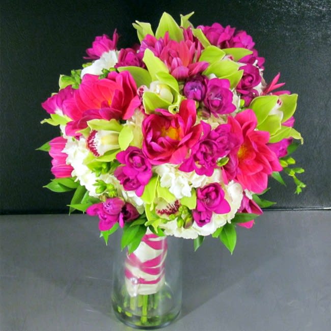 White, Fuschia and Green Bridal - The bridal bouquet is one of the most important elements of the bride’s ensemble. It is a once-in-a-lifetime accessory, and as such, it deserves special attention. Consider this simply exquisite bridal bouquet of White Hydrangeas, Fuschia Dahlias, Green Cymbidium Orchids and Fuschia Freesias.  Deluxe package includes Bridal and Toss Bouquet  View image gallery for matching Bridesmaids Bouquets and other wedding flowers. Also, keep in mind that all of our work is custom and we can customize any bouquet to match your colors for a wedding any time of the year. Contact us to discuss color options or to schedule a complimentary wedding consultation.