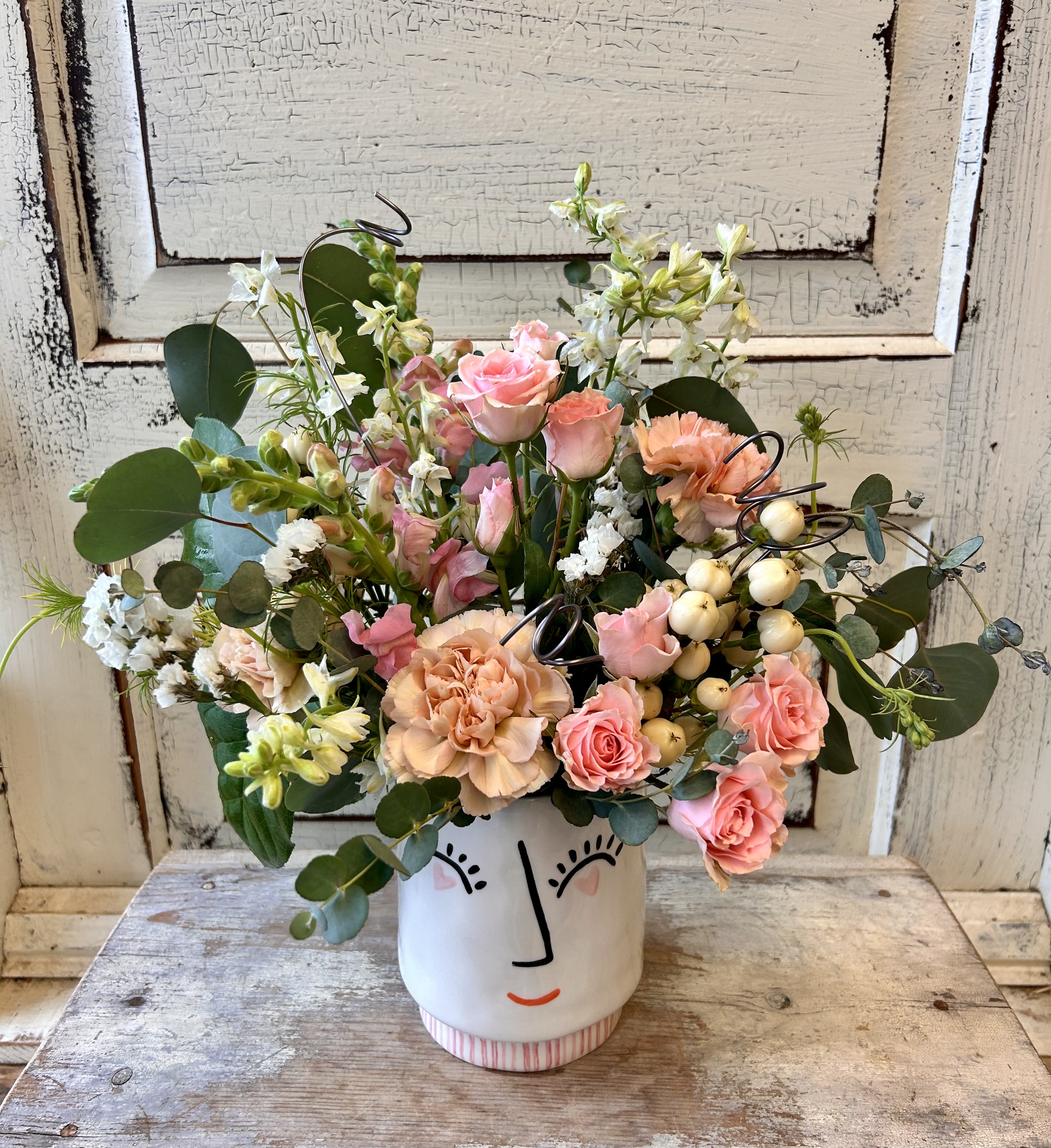 Heart Eyes - An adorable container with a smiling face and heart shaped eyes contains an assortment of fresh seasonal flowers. Colors and varieties used be our designers will vary with cooler inventory. 