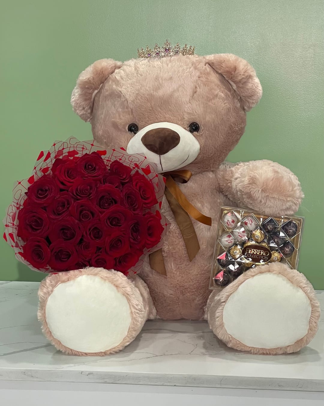 Love Gift Set  - This grand gift set has an extra-large teddy bear, chocolate and a wrap bouquet of red roses, finished with an opal crown. 
