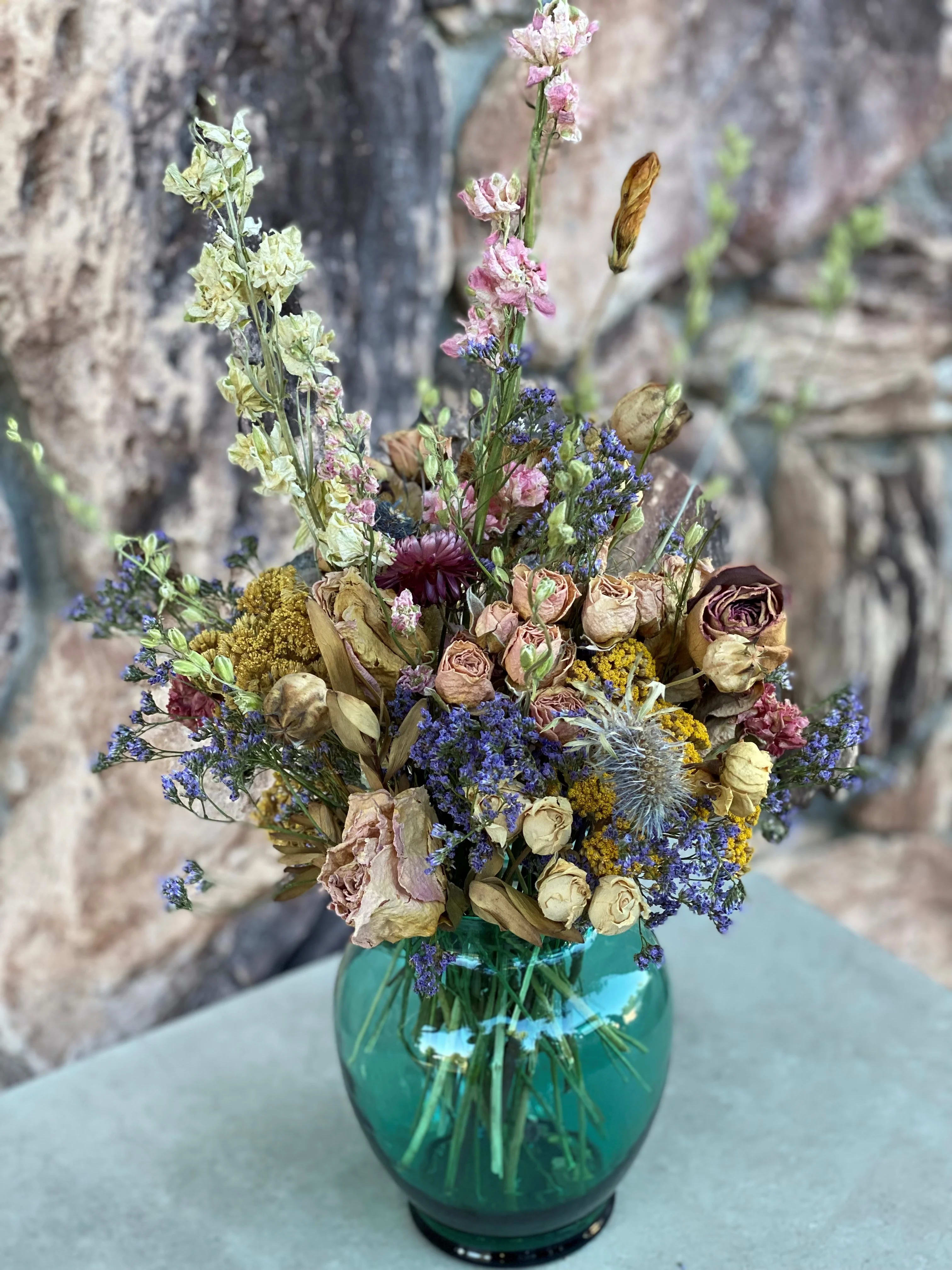 Dried Symphony  - A unique arraignment assembled with an assortment of dried flowers. Let this arrangement brighten some special someone's day. 