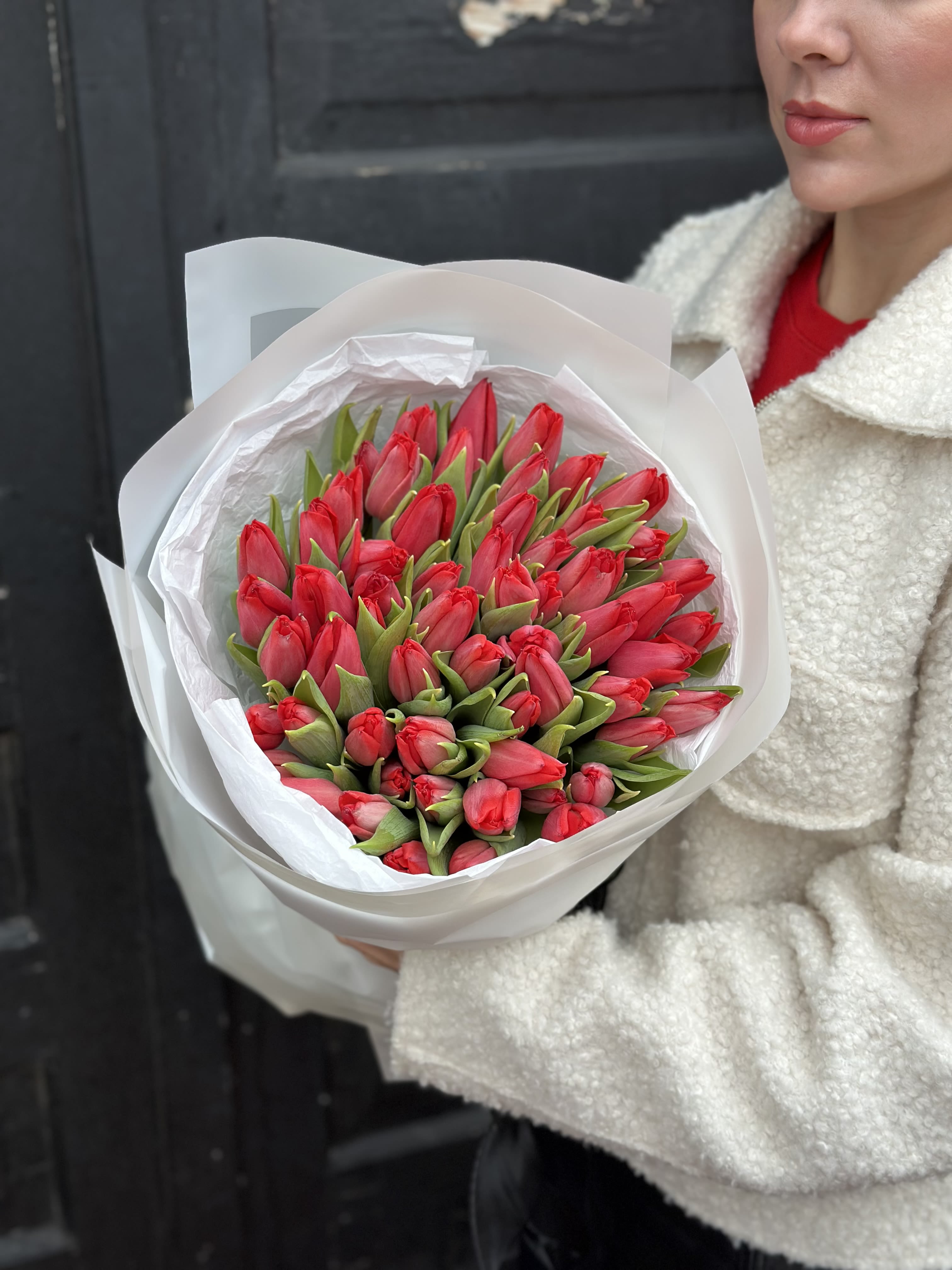 Crimson Whisper Tulips - A refined bouquet of fresh red tulips, symbolizing deep love, warmth, and quiet passion. Carefully hand-wrapped in soft white paper, this arrangement feels elegant yet effortless — perfect for expressing heartfelt emotions without saying too much. Ideal for romantic moments, meaningful gestures, or simply to brighten someone’s day with timeless beauty.