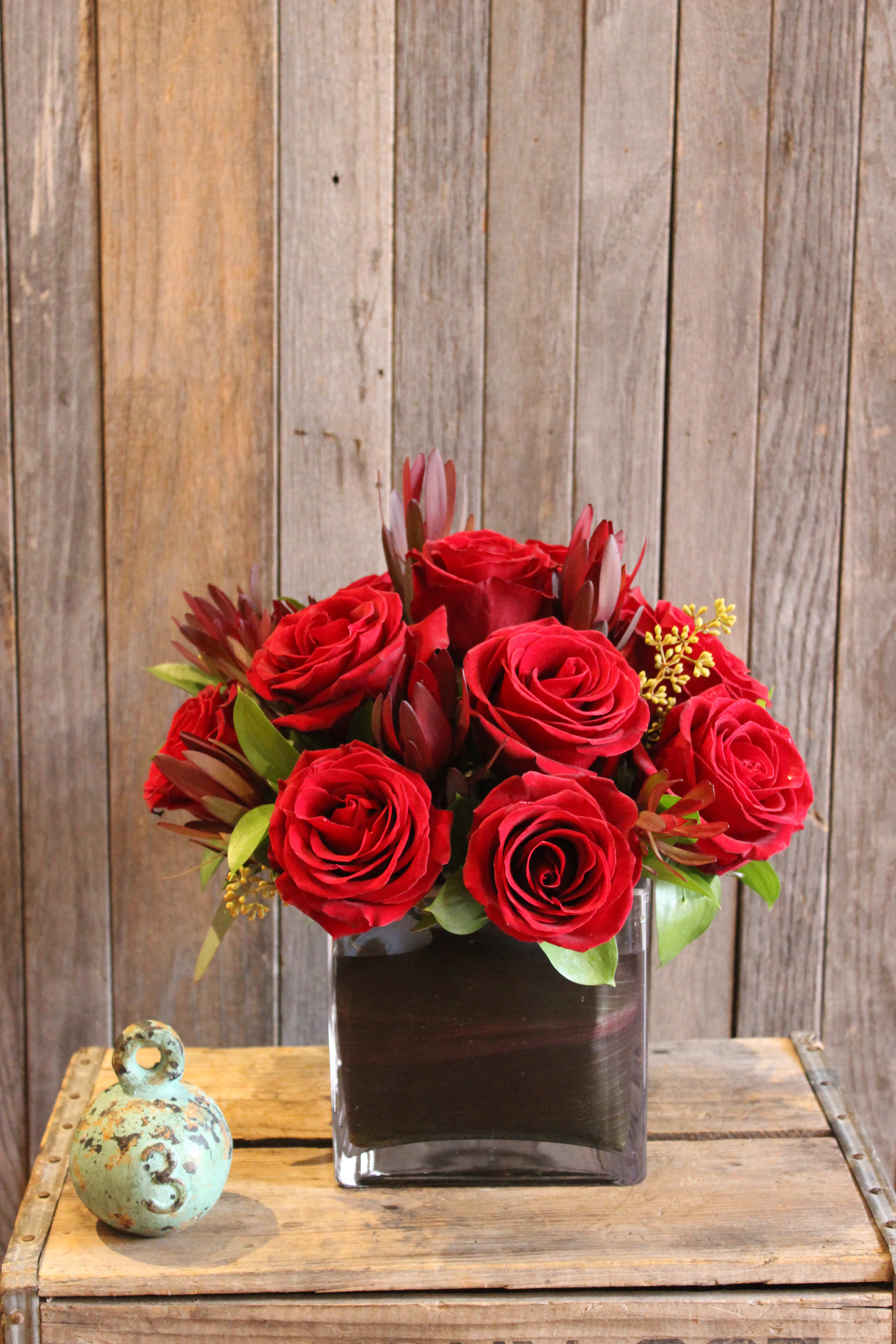 Modern Dozen - If you aren't a huge fan of the classic dozen rose look, but still want the romance of the dozen roses, then this is the perfect choice! Our contemporary twist on a classic offers a sophisticated look and is available in other colors- just indicate your first and second choice under Special Instructions.