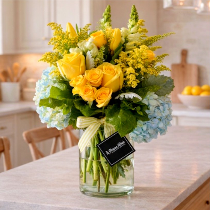 Yesterday  - Yesterday we all laughed, shared stories and made memories that will last a lifetime. Now, get the classic beauty of those memories in a single bouquet with Yesterday! This stunning arrangement includes yellow roses, yellow tulips, white snapdragons and blue hydrangeas expertly arranged in a clear vase. Whether sending a joyful surprise to your family or friends, make Yesterday even brighter with the perfect floral pick-me-up!