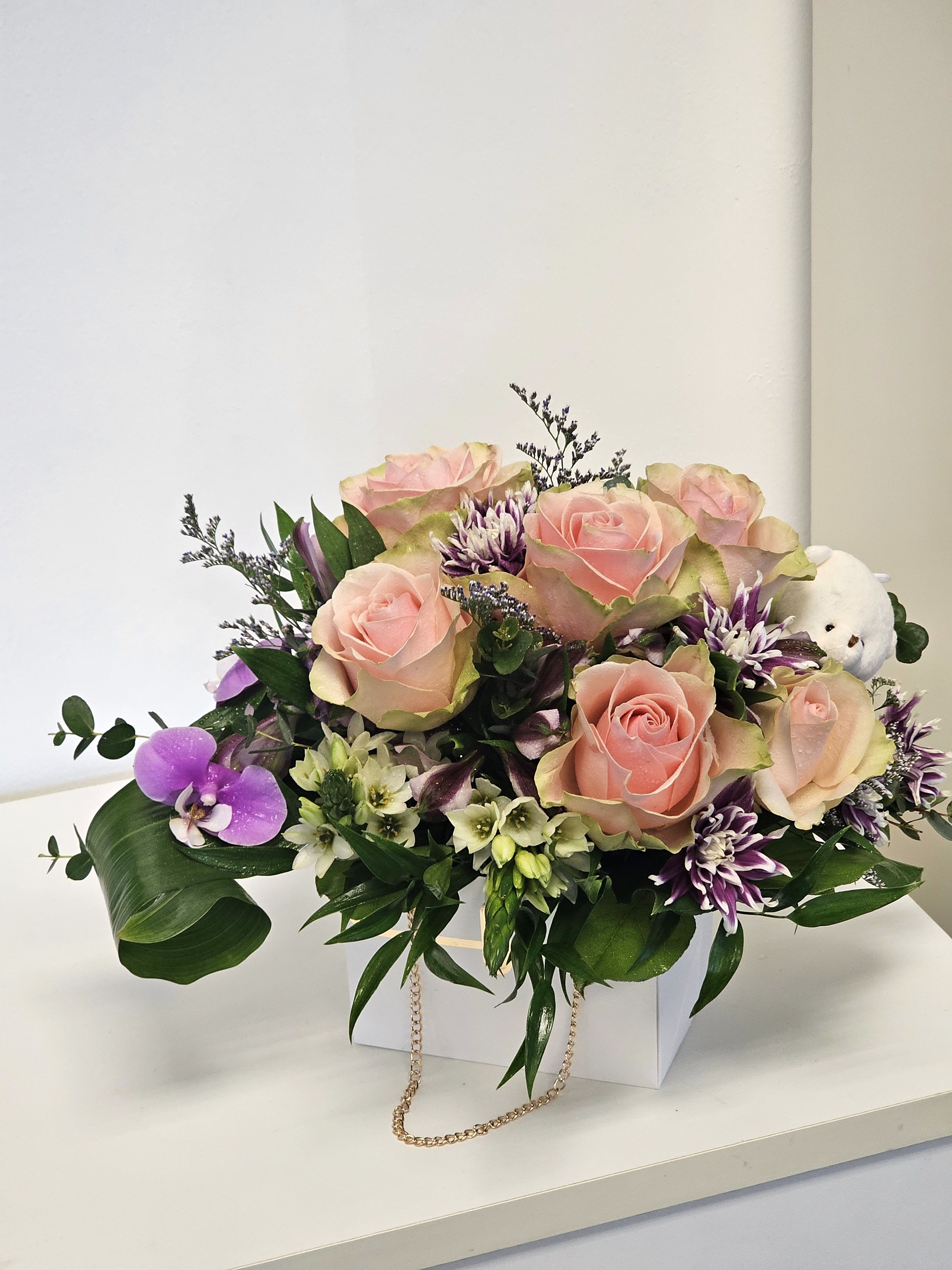 Beautiful arrangement with teddy bear  - This enchanting arrangement features a soft, plush teddy bear nestled among a lush garden of delicate flowers. 