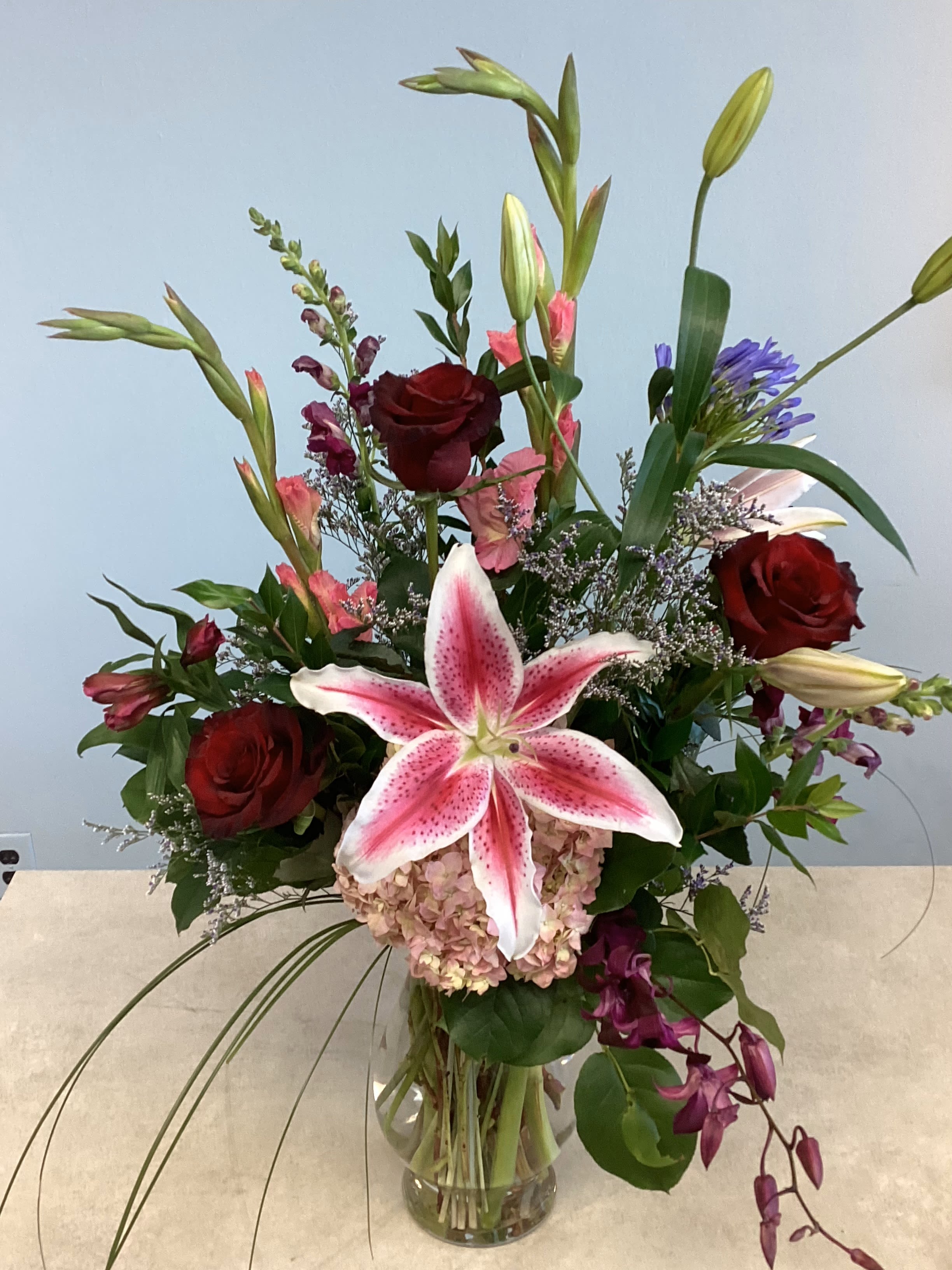 V-5 - A traditional spring mix of lilies, roses, and other coordinating flowers. 