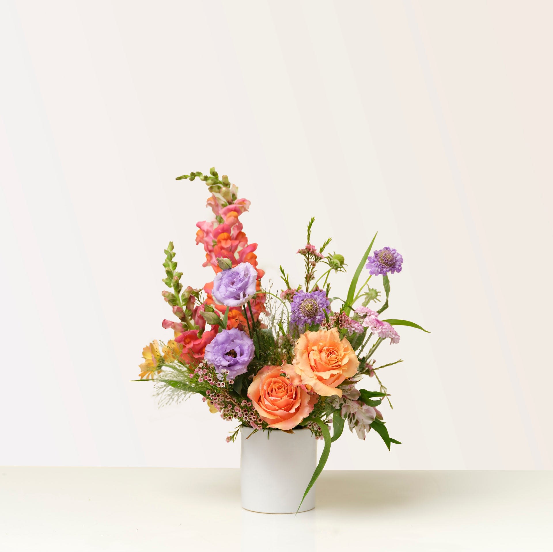 My heart belongs  - A lush, garden-style flower bouquet.  Designed in a modern stone pedestal vase, it’s a romantic statement piece perfect for luxury gifting or elegant tables.