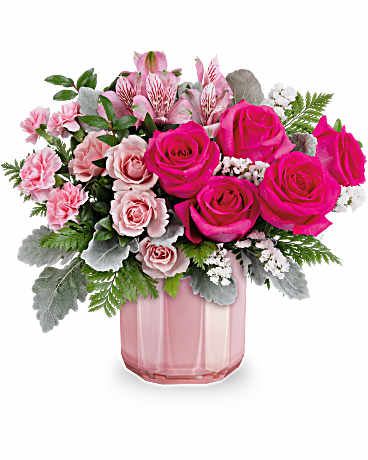 Blushing Gem Bouquet - DESCRIPTION VASE SIZES Keep them blushing with the most beautiful pink Valentine's Day bouquet, elegantly displayed in a sculpted pink glass vase featuring a stunning pearlescent finish. This Valentine's Day arrangement showcases hot pink roses, pink spray roses, pink alstroemeria, miniature pink carnations, white sinuata statice, dusty miller, huckleberry, and leatherleaf fern. This beautifully pink bouquet is delivered in Teleflora's Blushing Gem Vase. Orientation: All-Around