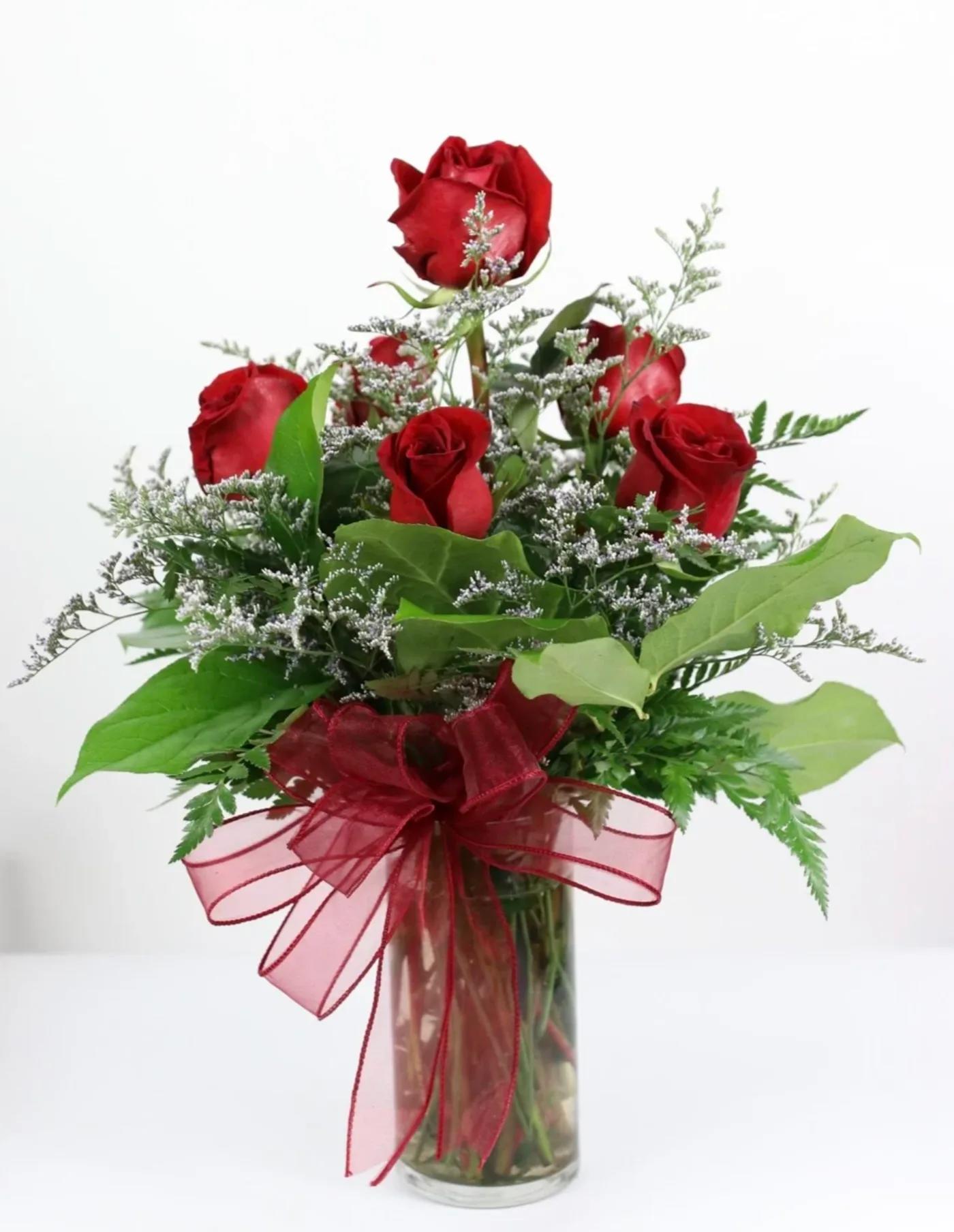 Half Dozen Red Roses - 6 artfully arranged red rose in a glass vase with seasonal filler.