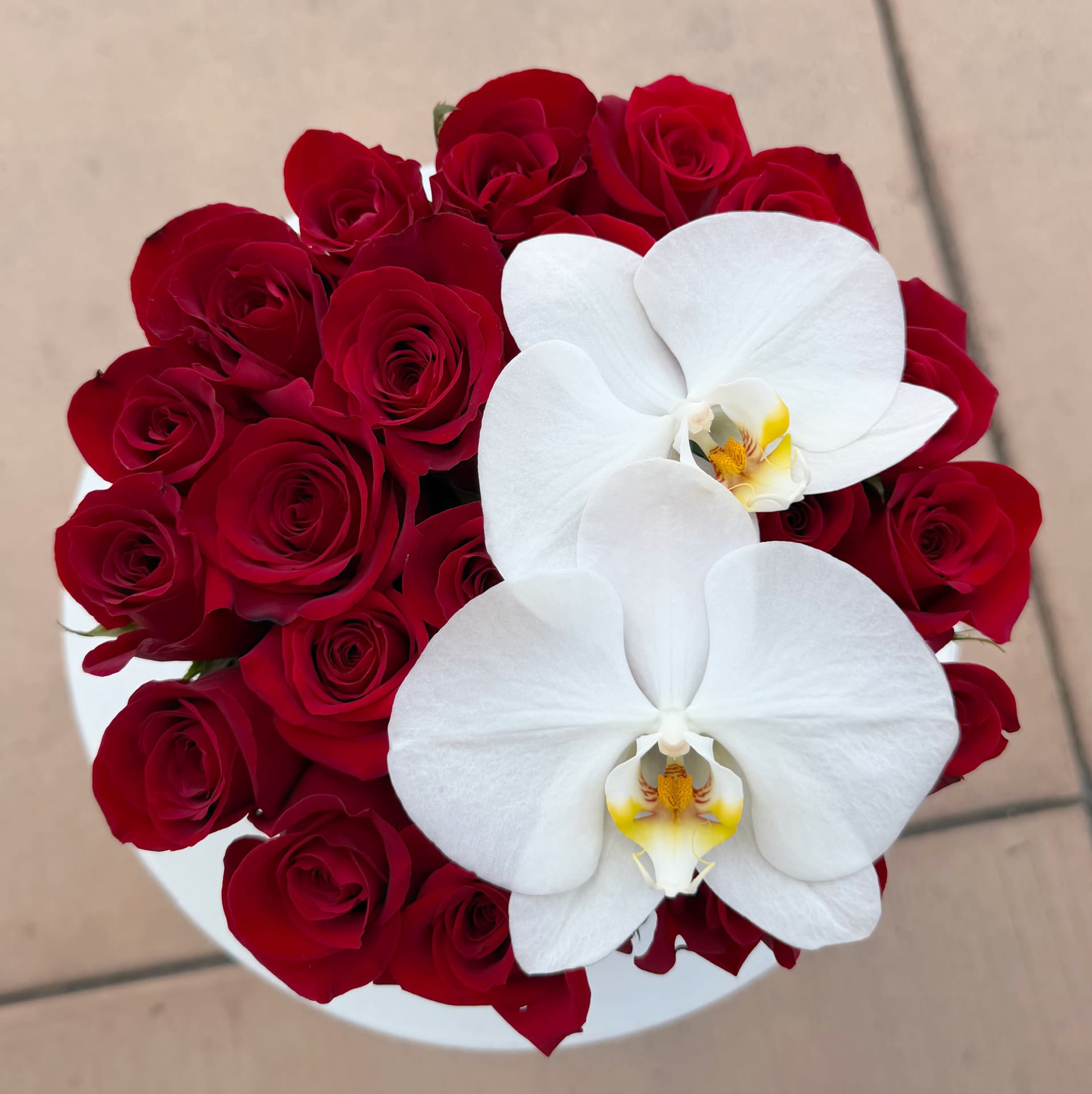 I love you (mini)  - A petite yet powerful expression of love, the I Love You Mini features lush red roses crowned with elegant white orchids, beautifully arranged in our signature romantic keepsake box. Sweet, refined, and timeless — this smaller version delivers the same heartfelt impact in a perfectly charming size.