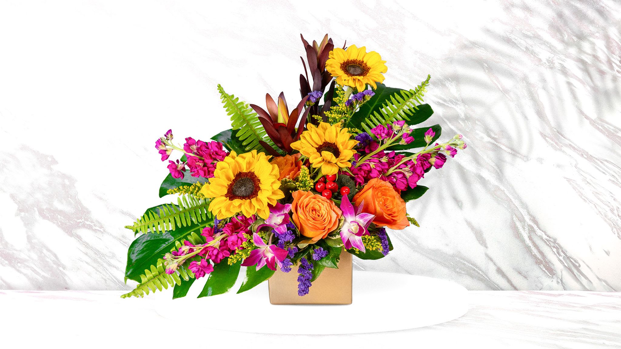 Flower Fashionista  - This unique design includes sunflowers, stock, roses, safari sunset , orchids, and tropical foliage 