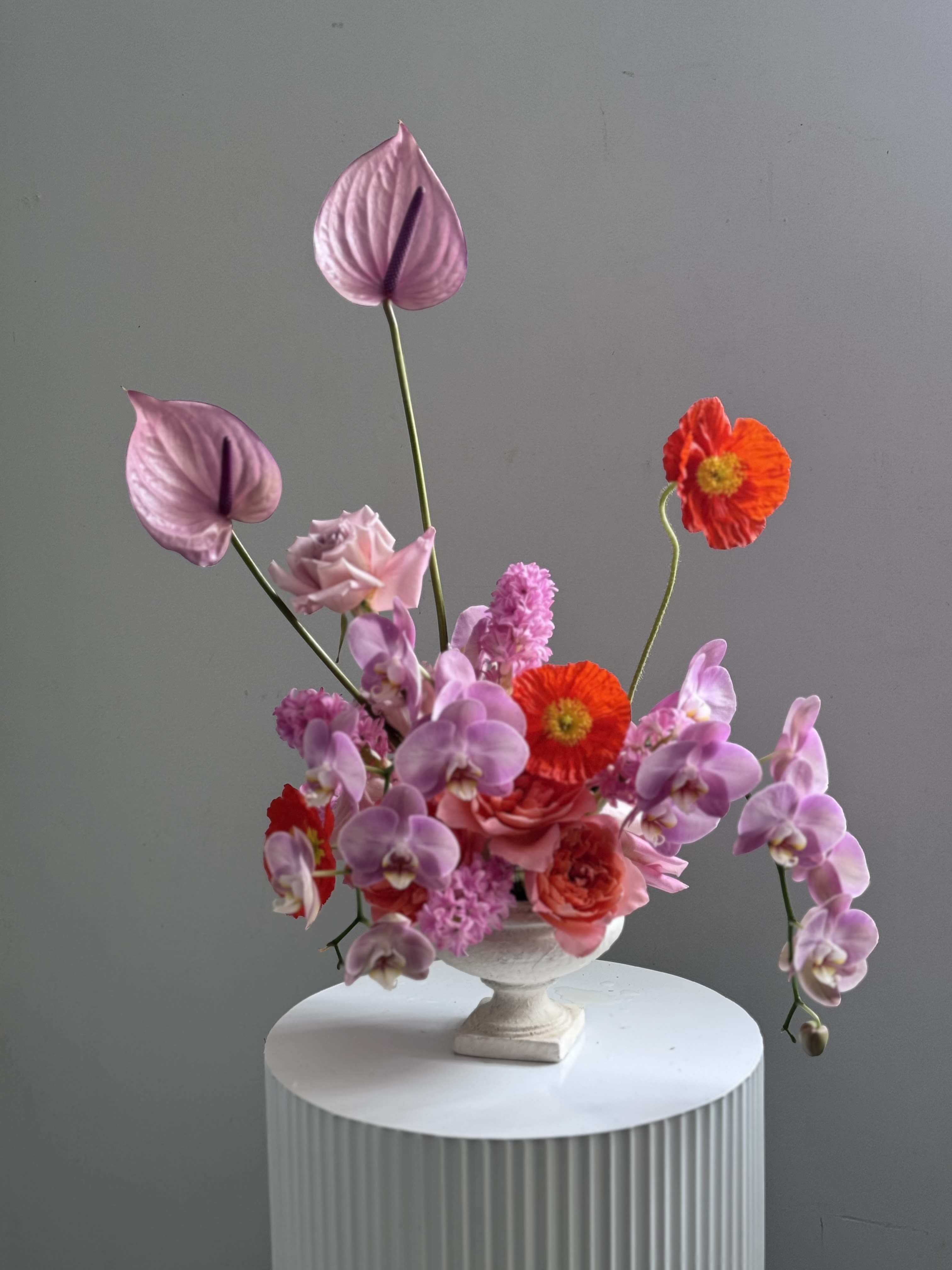 Blushing Orchid Garden - Blushing Orchid Garden - Blushing Orchid Garden, a captivating blend of luxurious orchids and timeless garden roses. Soft blush orchids, with their delicate, exotic petals, take center stage, exuding a sense of refined beauty and grace. Surrounding them, full-bloomed garden roses in gentle shades of blush and ivory add a romantic, classic charm, creating a soft, sophisticated contrast.