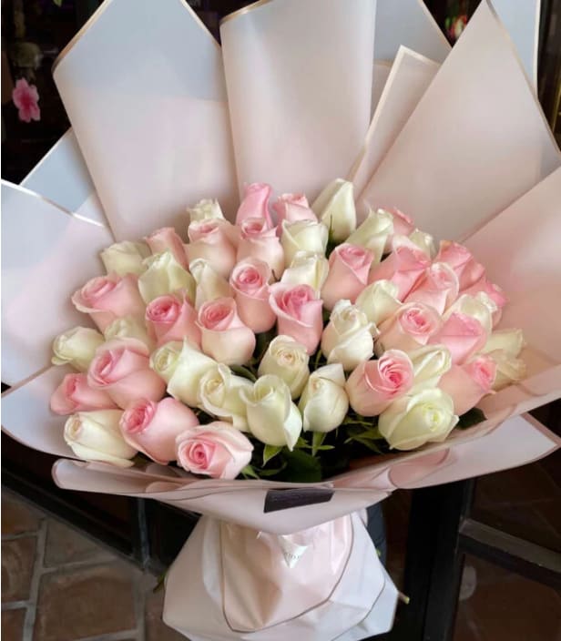 Pink &amp; White Roses - 50, 75 or 100 roses  Pink &amp; White Roses Elegant and timeless, the Pink &amp; White Roses bouquet is a perfect harmony of softness and sophistication. The gentle blush tones paired with classic white roses create a graceful arrangement that speaks of purity, admiration, and love.      •    A luxurious combination of fresh pink and white roses     •    Available in three sizes: Standard, Deluxe, and Premium     •    Wrapped in sleek, minimalistic paper for a modern look     •    Perfect for weddings, anniversaries, or celebrating life’s sweetest moments  VASE NOT INCLUDED 