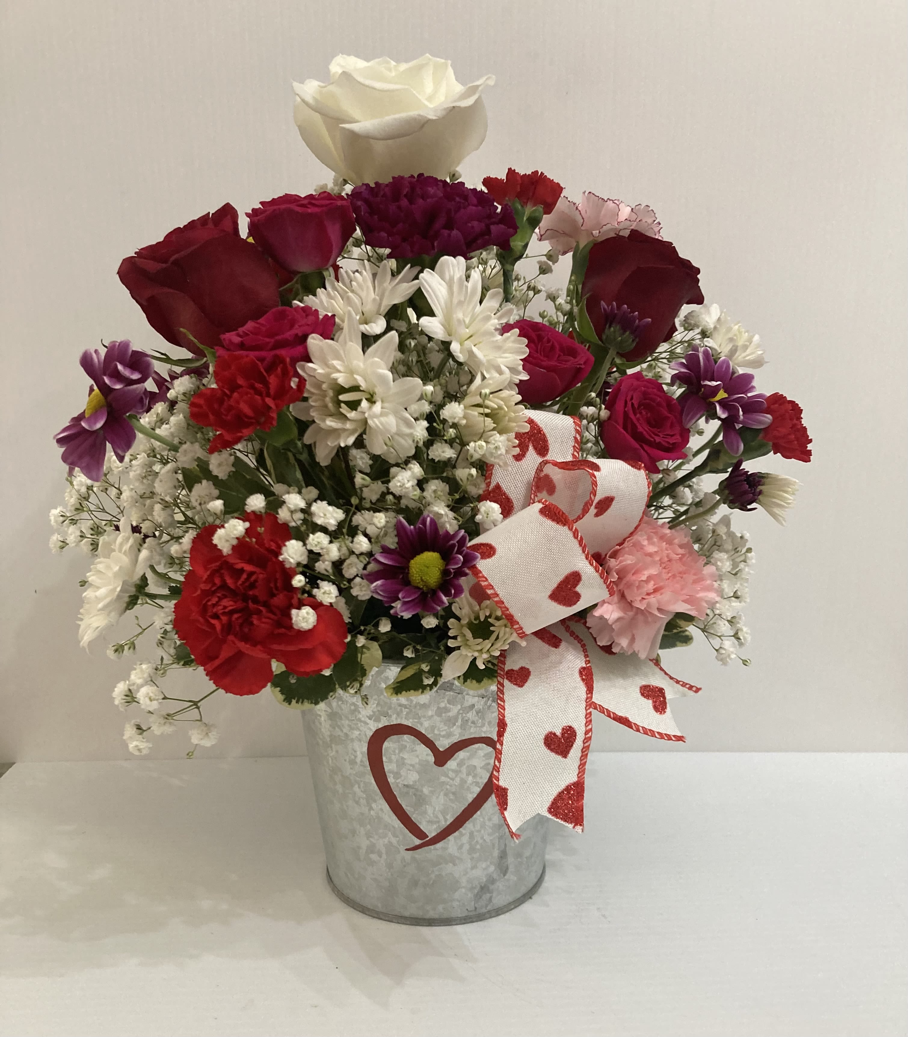 Hugs and Kisses  - Small decorative pot with roses, spray roses, daisy, carnations and greens with 8 piece delicious premium chocolates