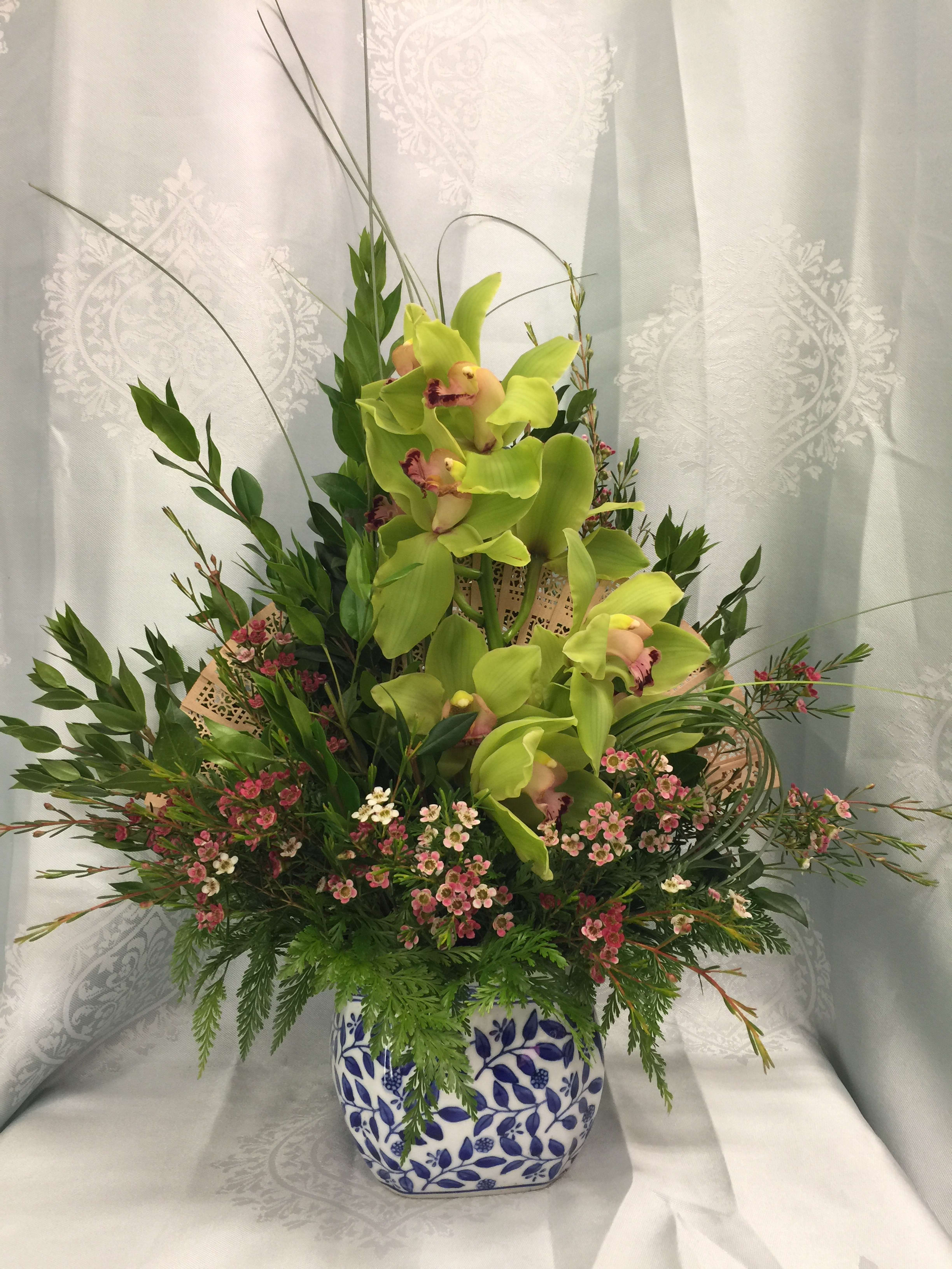 Cymbidium Fan Floral arrangement - Asian stylized New Zealand cymbidium orchid designed with fan in the background gives a distinct oriental feel. 