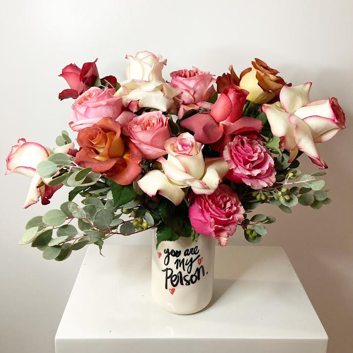 You Are My Person - A baker’s dozen of breathtaking roses, rich in color and texture, overflow from this charming ceramic vase. These blooms say, you are my person—loud and clear. Want to turn up the romance? Upgrade to Deluxe or Premium for even more rose-filled joy.  *** Please note that if necessary, the vase may vary due to availability but will remain similar in style. ***