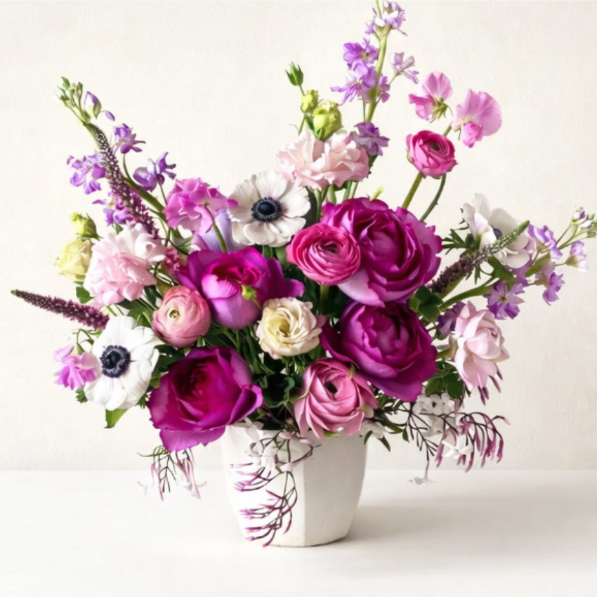 Pink Sonata - A bold yet soft and delicate arrangement featuring lush hot pink roses paired with delicate white anemones, Japanese sweet pea, Italian ranunculus, stock, and premium florals in season. Soft yet bold, this bouquet is a beautiful expression of love—sweet, graceful, and unforgettable.