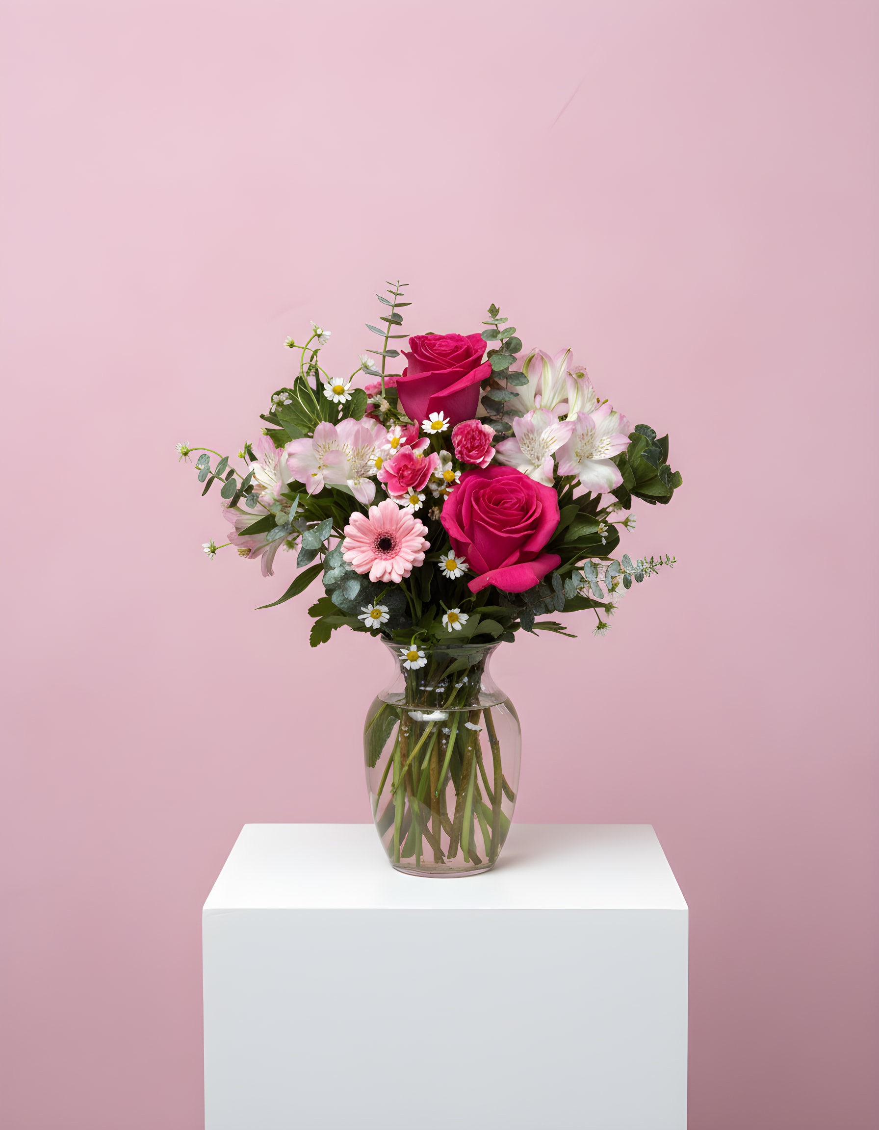 Pink Garden - Pink roses with alstroemeria, mini gerbera, and carnations in a glass vase.