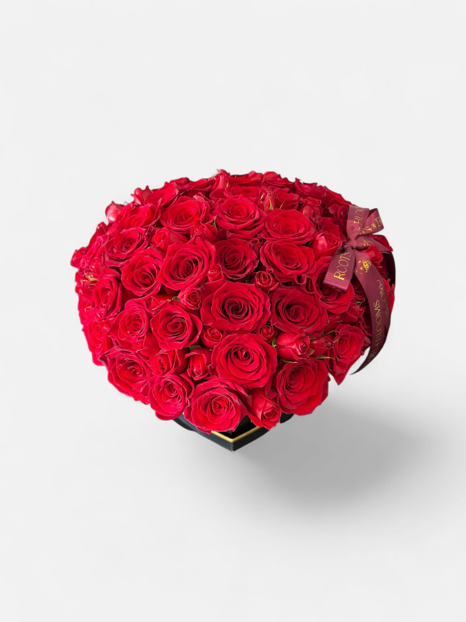 Scarlet Heart - An opulent heart of velvety red roses arranged to perfection in modern black base. Bold, dramatic, and unforgettable -created for moments that deserve nothing less than extraordinary. 