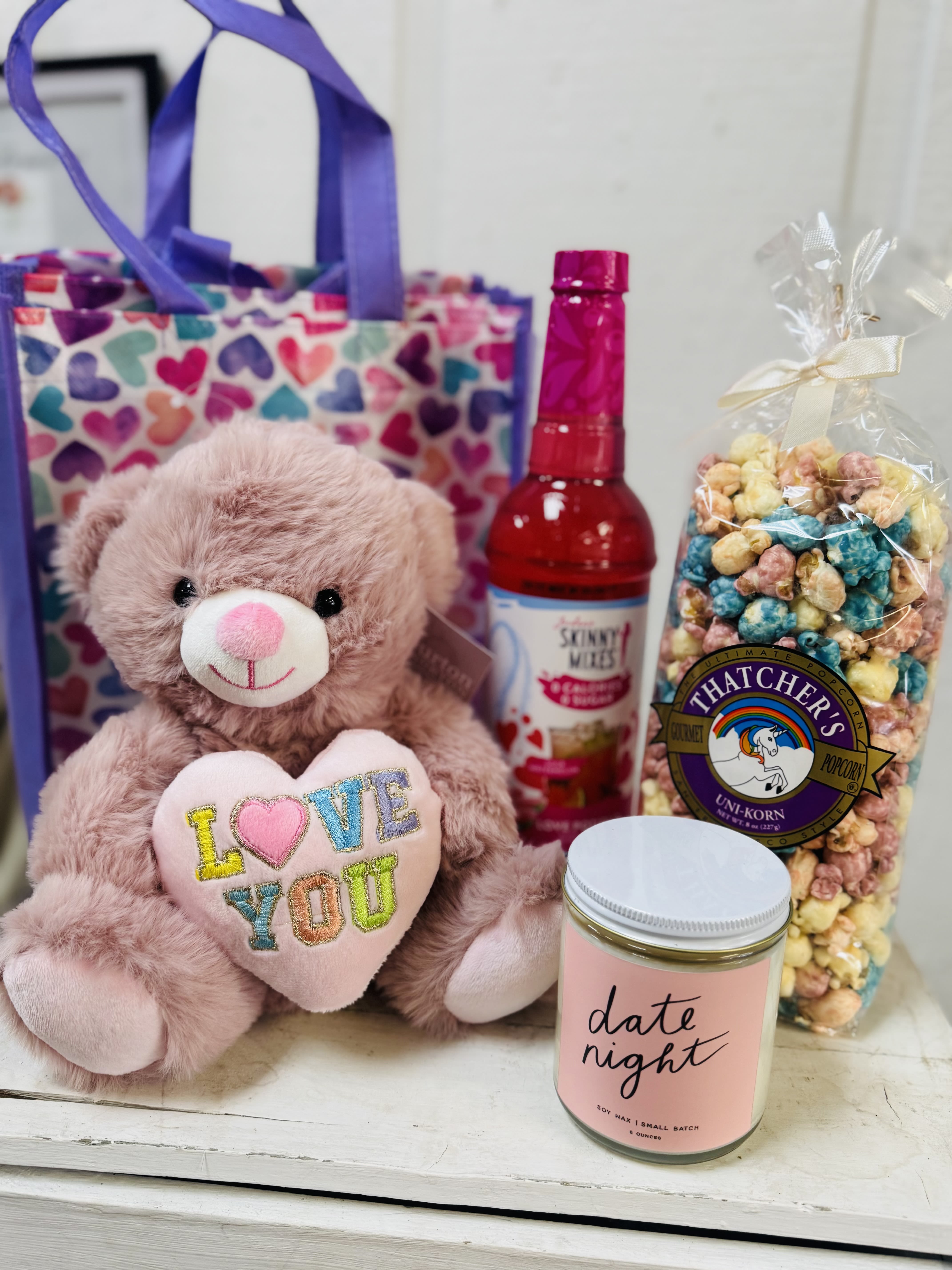 Date Night Collection - All the gifts in one sweet gift bag! Love potion skinny syrup mix, unicorn popcorn, date night candle and the sweetest pink bear that says it all, "Love You" 