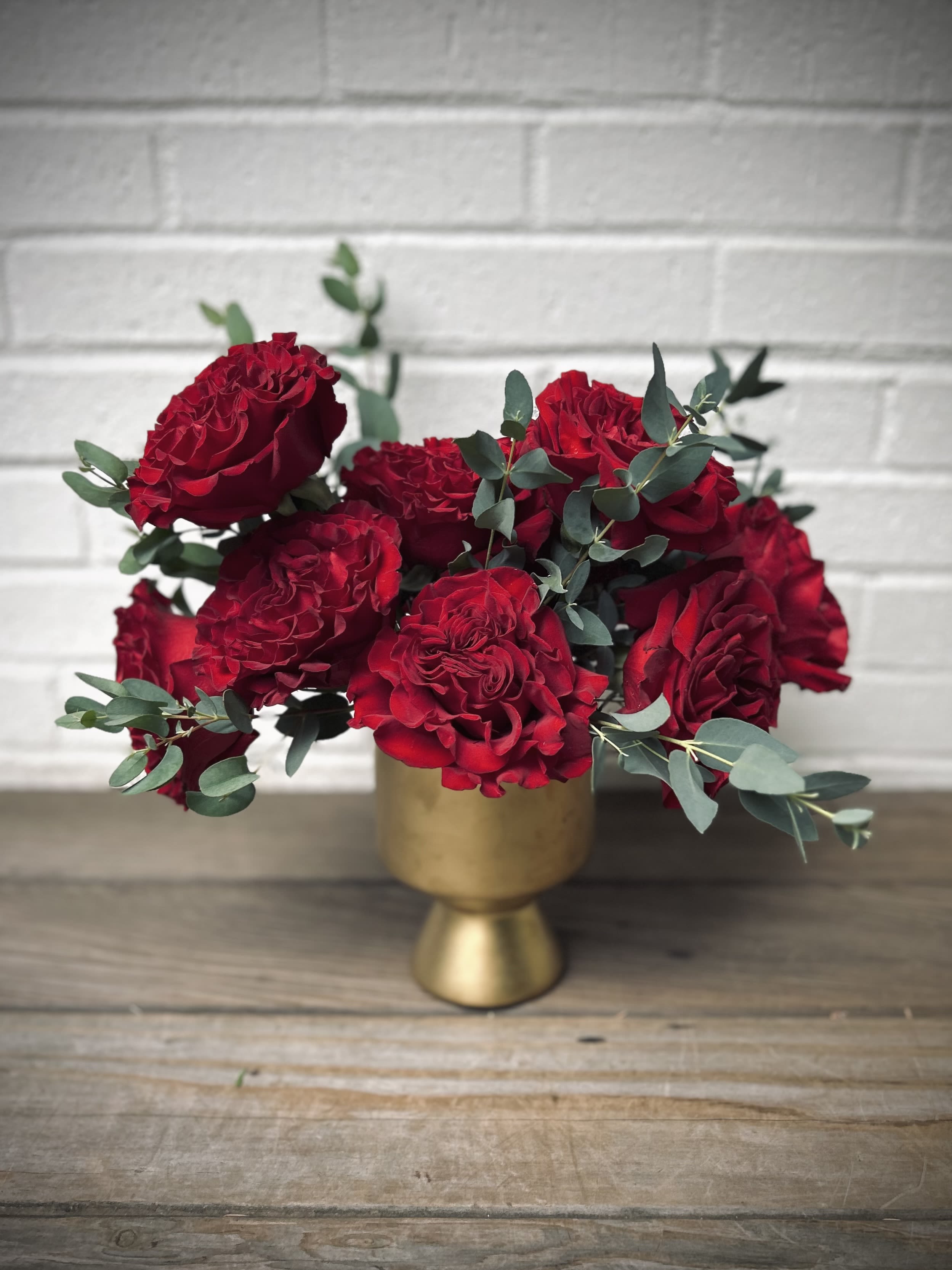 Simply Red - One dozen Hearts garden roses gathered in a gold ceramic vase.