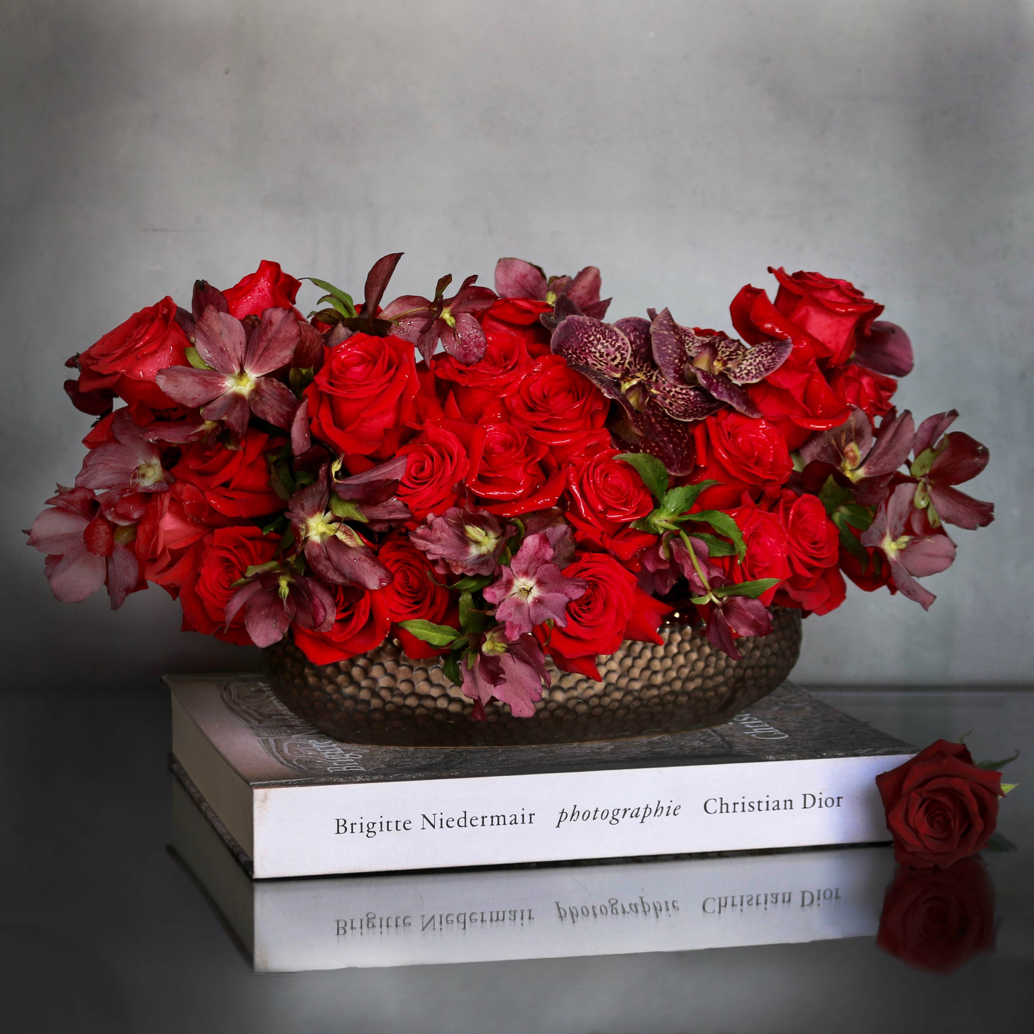 Adore Me  - "Adore Me" is a romantic and rich arrangement filled with beautiful red Roses &amp; Orchids. Arranged within a long ceramic vase. Beautifully made for that someone special !  Measurement:  Vase: 3x11 Arrangement: 9x16 