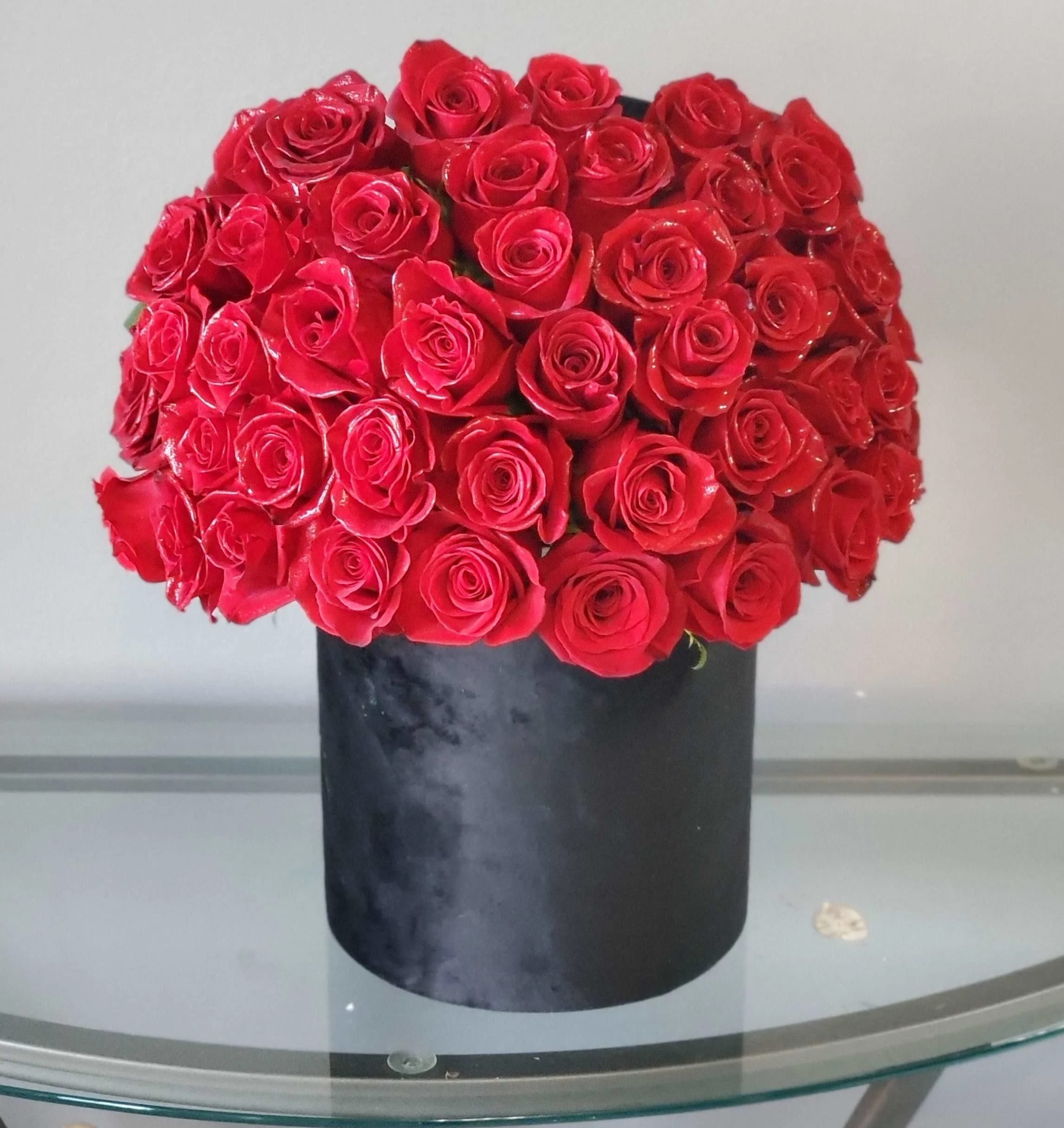 Red Rose Heaven - A romantic gesture for any day or a special occasion.  Our premium red roses in a  black Vase.  Approximately 40 count.