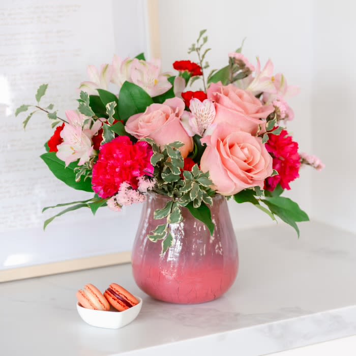 Pretty in pink  - Radiating soft sophistication, tommy Austin Florist Pretty In Pink Bouquet blends pink roses, alstroemeria, and carnations in a translucent crackled glass vase with a pink gradient-a chic and heartfelt Valentine's Day gift for your one and only. pink roses, pink spray roses, pink alstroemeria, pink miniature carnations, white sinuata statice, huckleberry, and leatherleaf fern arranged in keepsake pink vase 