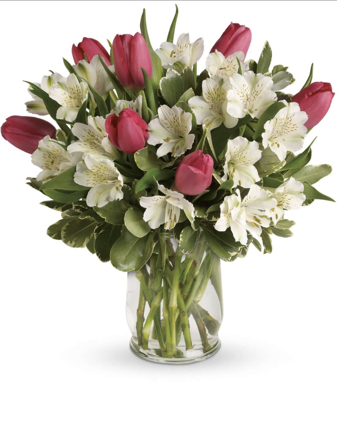 Blushing Garden - A graceful blend of vibrant pink tulips and delicate white alstroemeria, nestled in lush greenery and presented in a clear glass vase. Fresh, romantic, and effortlessly elegant — perfect for birthdays, thank-you moments, or just because.