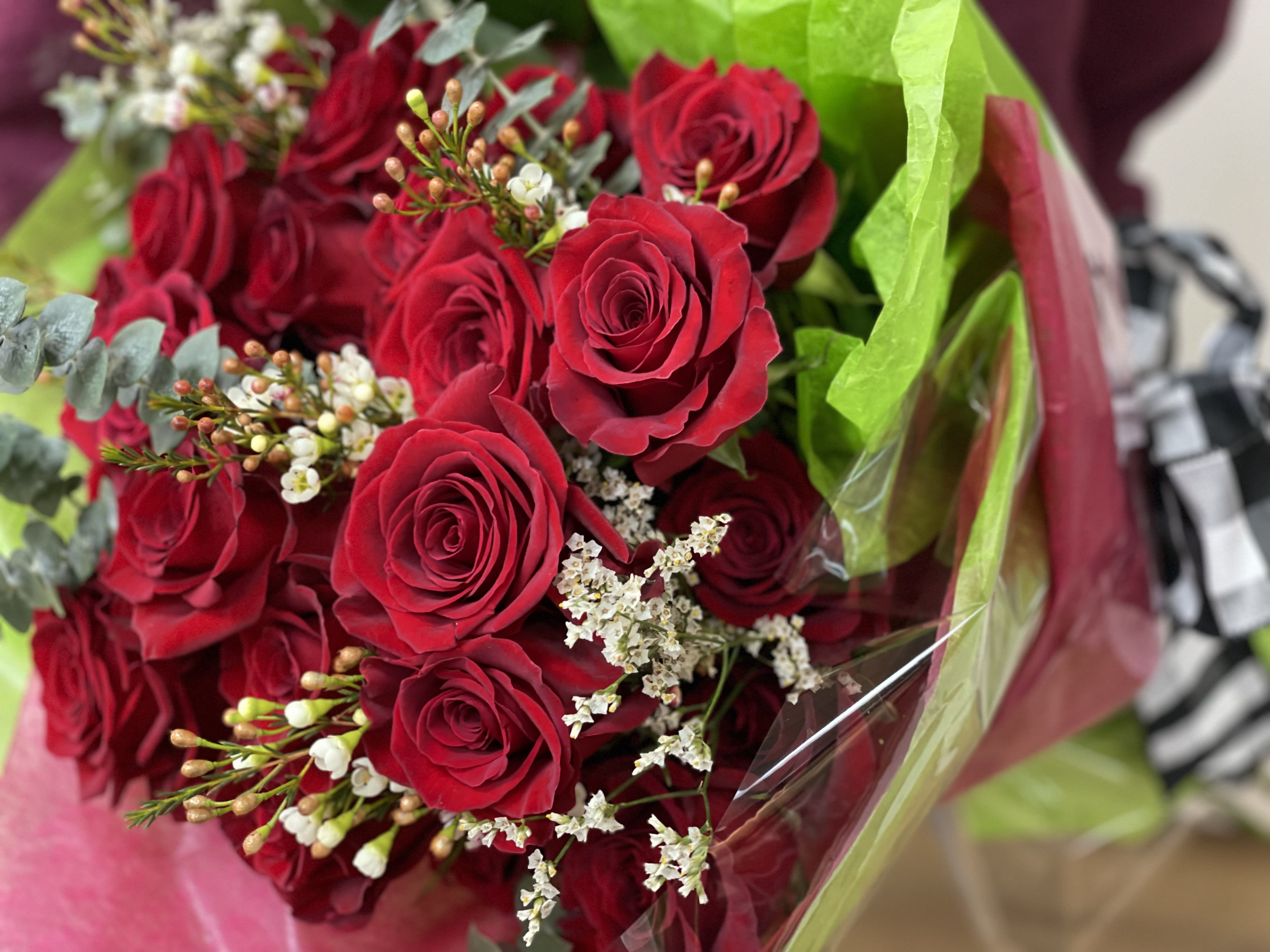 Bouquet of Roses. - A beautiful bouquet of a dozen roses with filler and luscious greens, gathered together with an elegant bow.