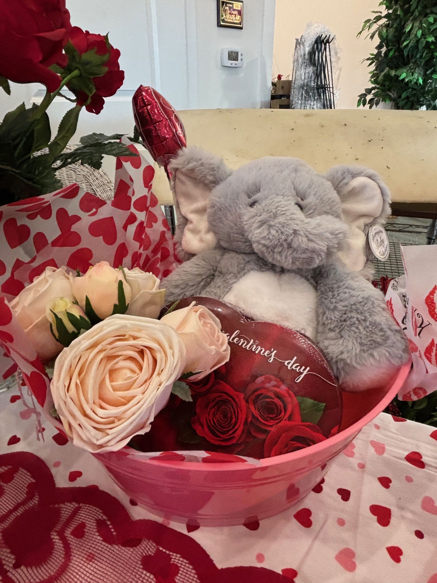 Pink Elephant Sweetheart Tub - A cute pink tub filled with artificial light pink roses, a cuddly stuffed elephant, and a box of candy — a sweet and cheerful Valentine surprise.