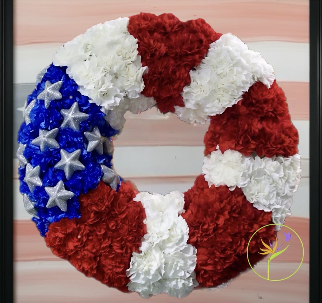 USA Flag. A Floral Archist™ original. - Which better and strongest way to reflect patriotism and devotion to one’s country, than our American flag designed in fresh flowers.  Custom design - handcrafted! 18 to 22 inches diameter*   *Wreath size depends on bloom’s size, not all flowers grow and open identically.  NOTE: Our flowers and greens are a gift from nature. It’s shade and depth might vary, design, aesthetic and value remains the same. In support of our efforts to aide in the preservation of our planet, PJf uses Fair Trade flowers, Plants, Upcycled and Recycled containers.