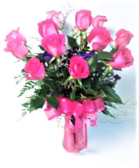 One dozen Hot pink Roses  - If pink is her color, this is it! One dozen hot pink roses in a clear vase. Vase or fillers may vary.