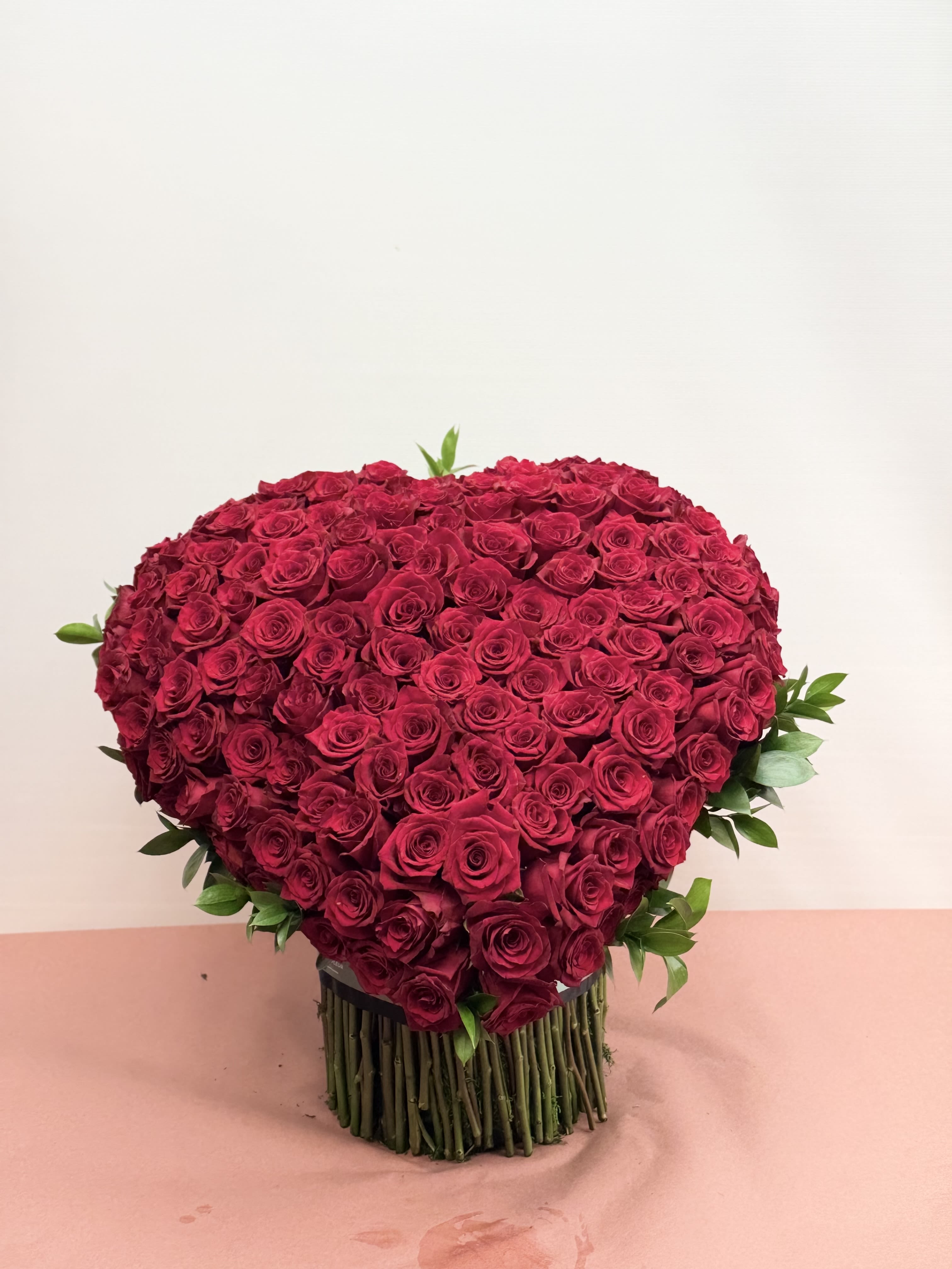Heart of Love – 160 Ecuadorian Roses - Make a bold, unforgettable statement with our Heart of Love arrangement. Hand-crafted in a romantic heart shape, this luxurious design features 160 premium, long-stem Ecuadorian red roses, known worldwide for their rich color, large blooms, and exceptional quality.  Each rose is carefully selected and arranged by our expert designers to create a full, dramatic silhouette that symbolizes deep love, passion, and devotion. This breathtaking arrangement is perfect for anniversaries, Valentine’s Day, proposals, or any moment when words simply aren’t enough.  Designed to impress and styled with elegance, this high-end rose arrangement is a true showstopper — timeless, romantic, and undeniably luxurious.  Details: 	•	160 high-end Ecuadorian red roses 	•	Hand-designed heart shape 	•	Premium, fresh-cut roses 	•	Designed by Sofi La Fleur 	•	Ideal for grand romantic gestures and luxury gifting  A heart made of roses, created to be remembered. ️