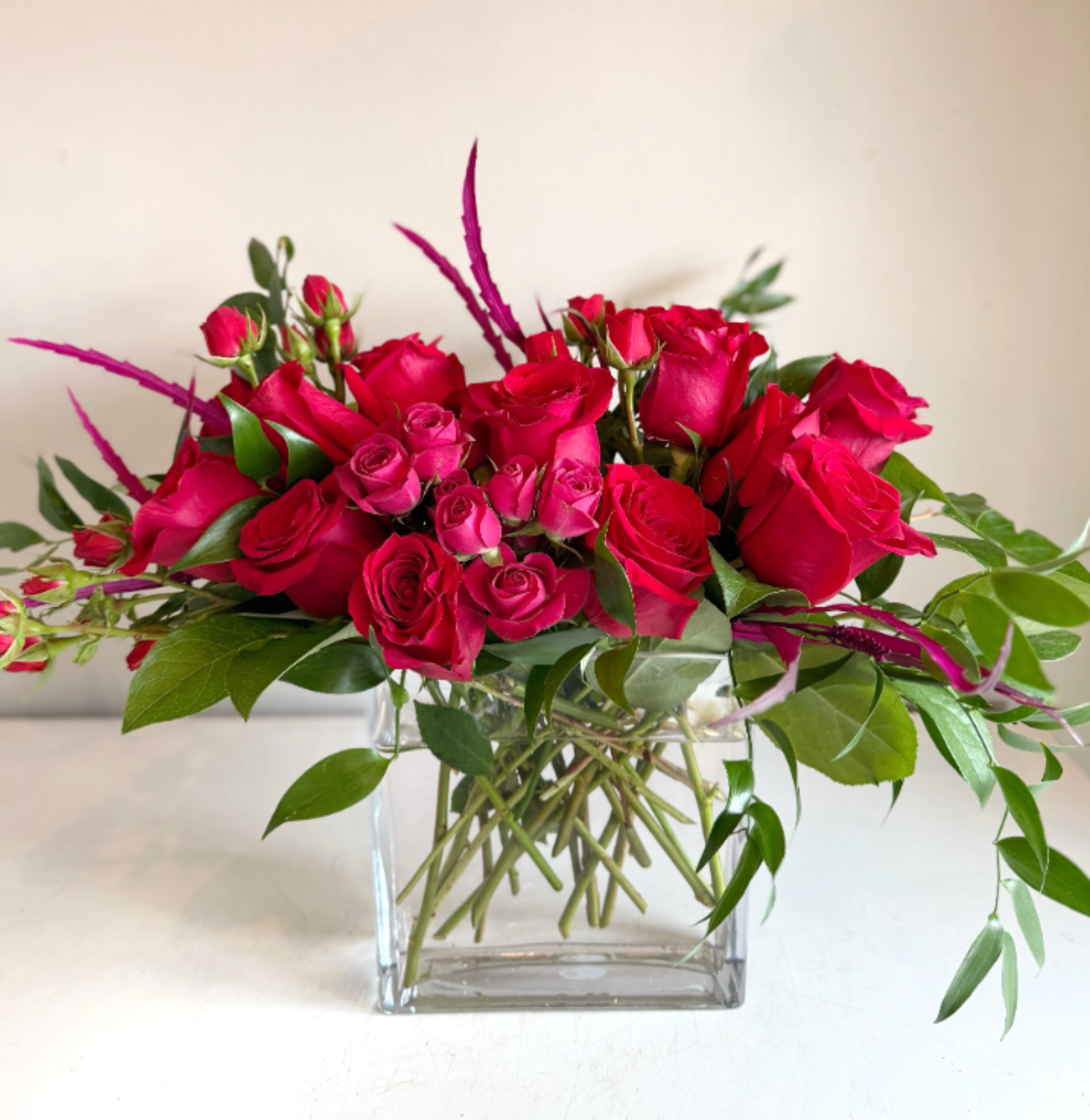 Velvet Heart - Love is in the air, and this classic arrangement of red roses with a touch of hot pink is the perfect way to express your love. Beautifully arranged in a clear rectangular vase.