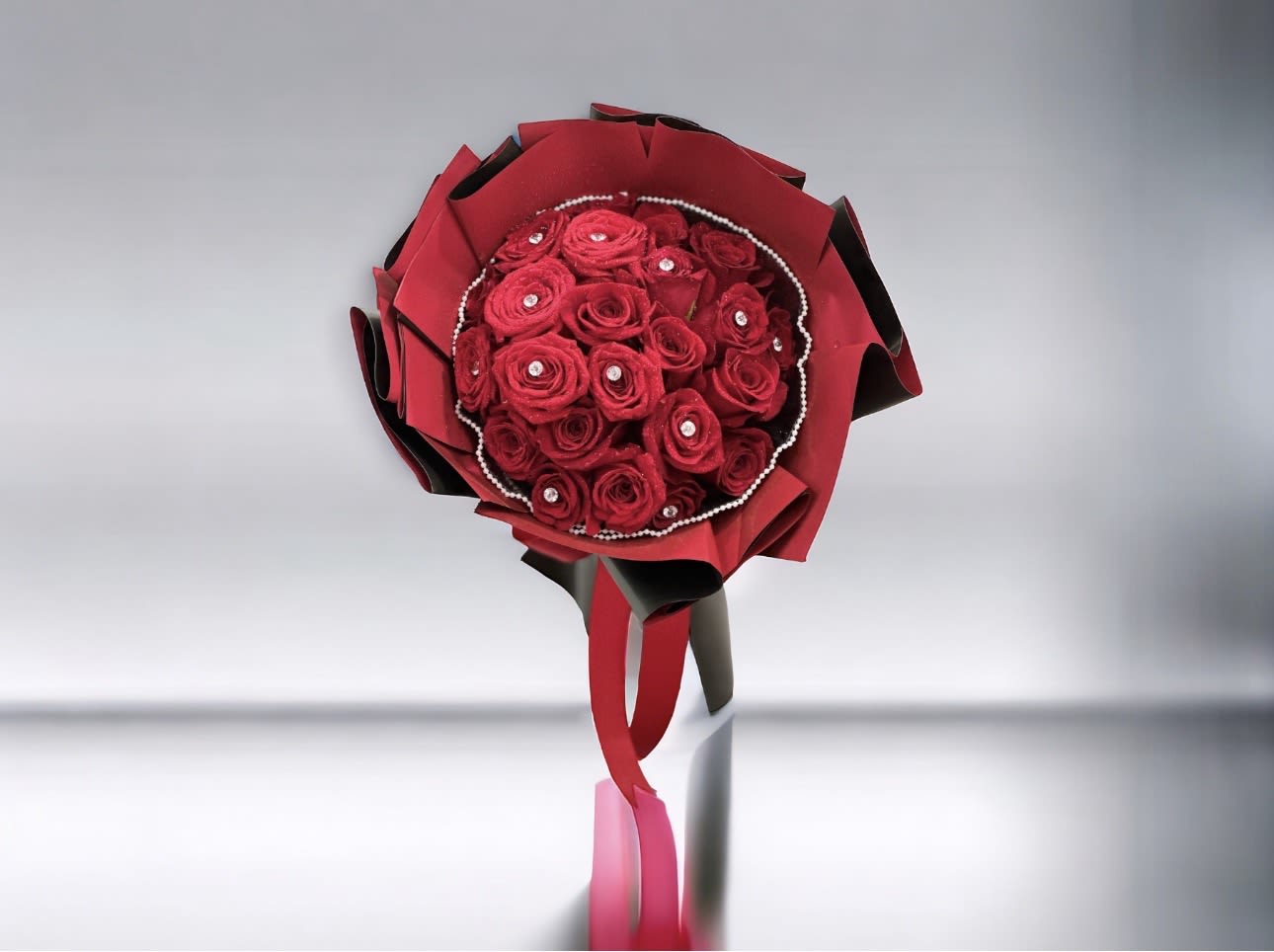 My Woman - A 24 bouquet of vibrant red roses adorned with delicate pearl accents, elegantly wrapped with matching red and black paper.