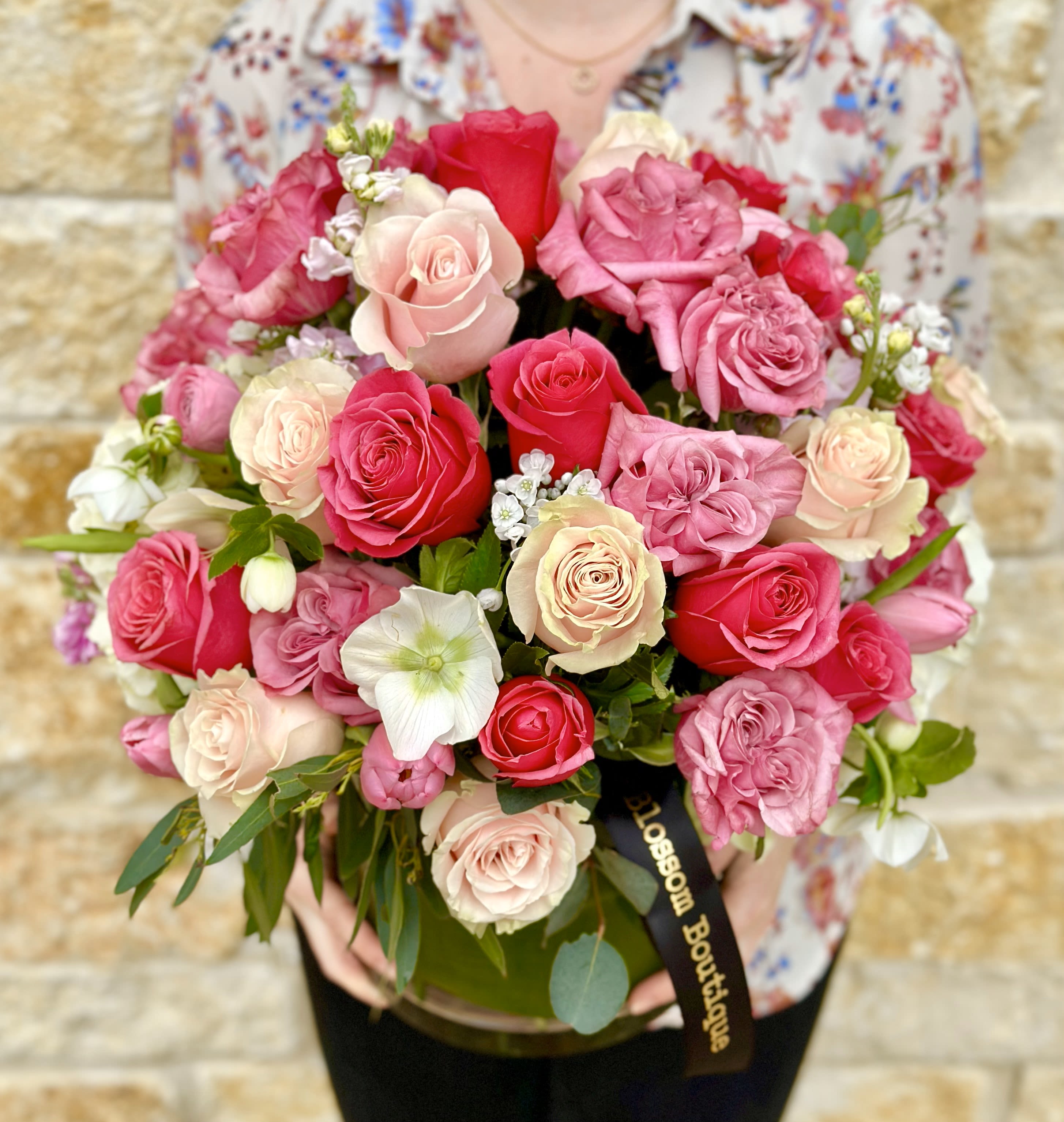 Lavish Pink Rose Garden - A lavish designer's choice arrangement in shades of pink roses and premium garden varieties like Hydrangea,  Ranunculus, Clematis and Tulips. A display of  romance that’s sure to WOW.  Arranged in a clear glass vase. Pictured as Deluxe Approximate dimensions 20" x 20" Rose color and vase may vary.  Standard- 3 dozen mixed roses + garden varieties Deluxe- 4 dozen mixed roses + garden varieties  