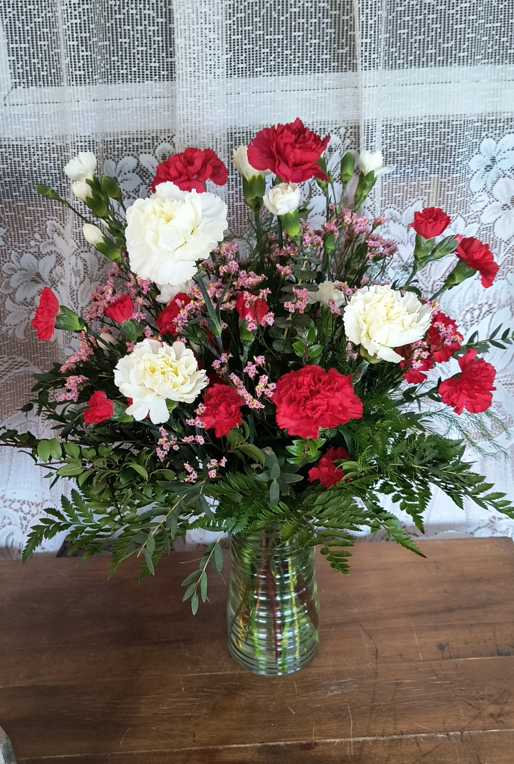 Valentine Hugs - Traditional and classic carnations in a designers choice of Valentine colors. A long lasting gift.