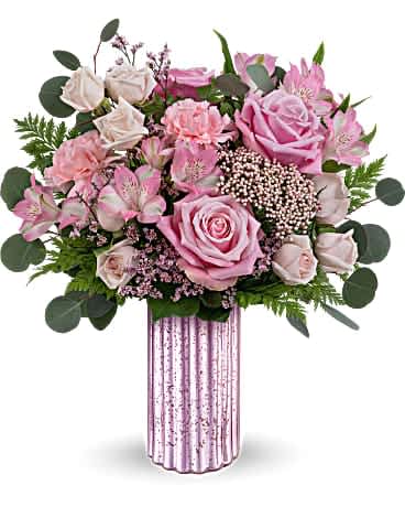 Teleflora's Amazing Pinks Bouquet - Sparkle with elegance and grace with the Amazing Pinks bouquet, nestled in the stunning lavender mercury-inspired finish vase, a timeless adornment perfect for Mother's Day and all year round. The Amazing Pinks Bouquet showcases a blend of pink roses, light pink spray roses, pink alstroemeria, pink carnations, leatherleaf fern, pink limonium, rice flower, and silver dollar eucalyptus, delivering a stunning Mother's Day gift in elegant lavender hues.