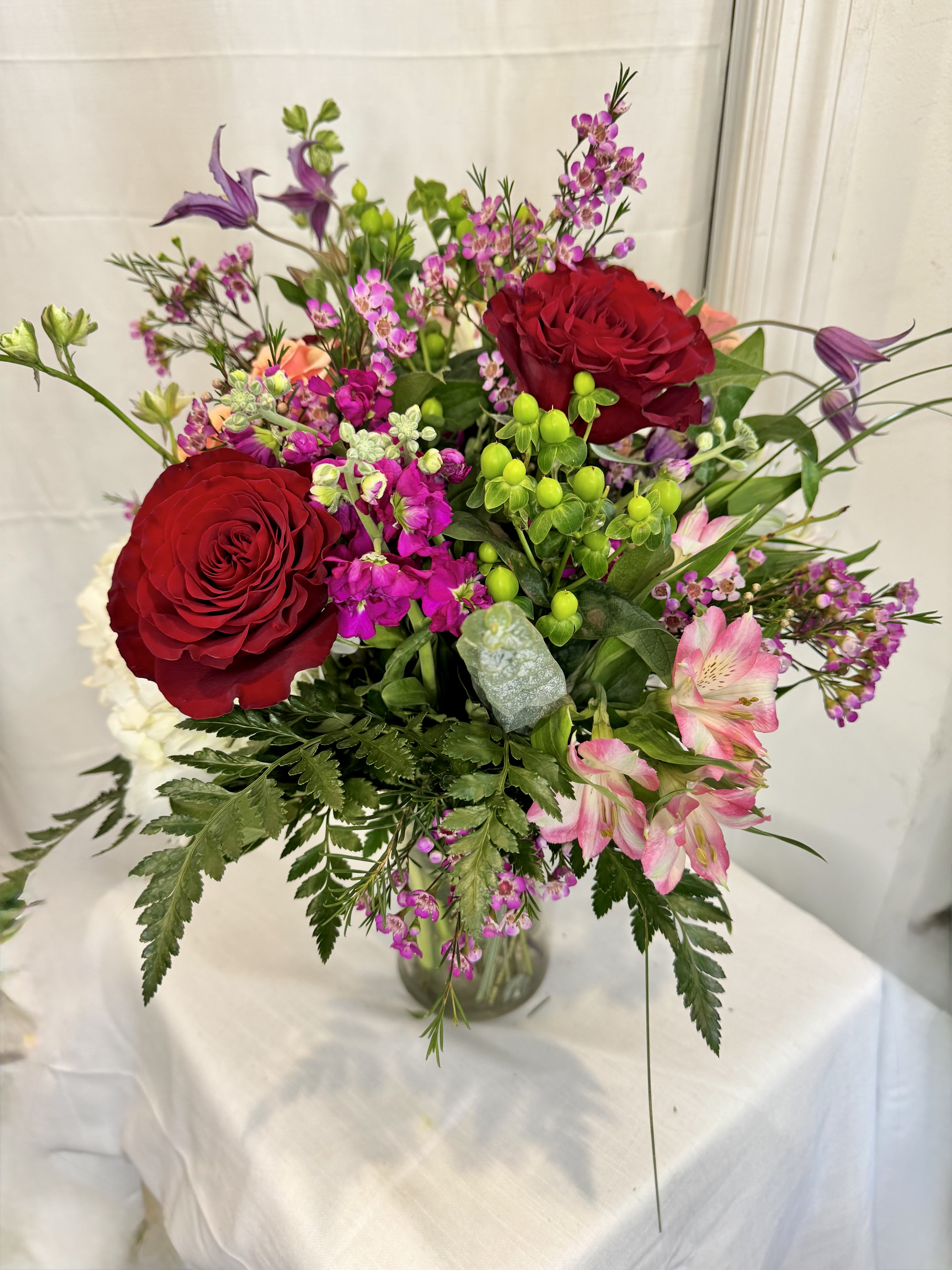Raindrops on Roses - Premium Red Roses mixed with a variety of airy florals and greenery. Perfect mix with classic reds and romantic palette. 