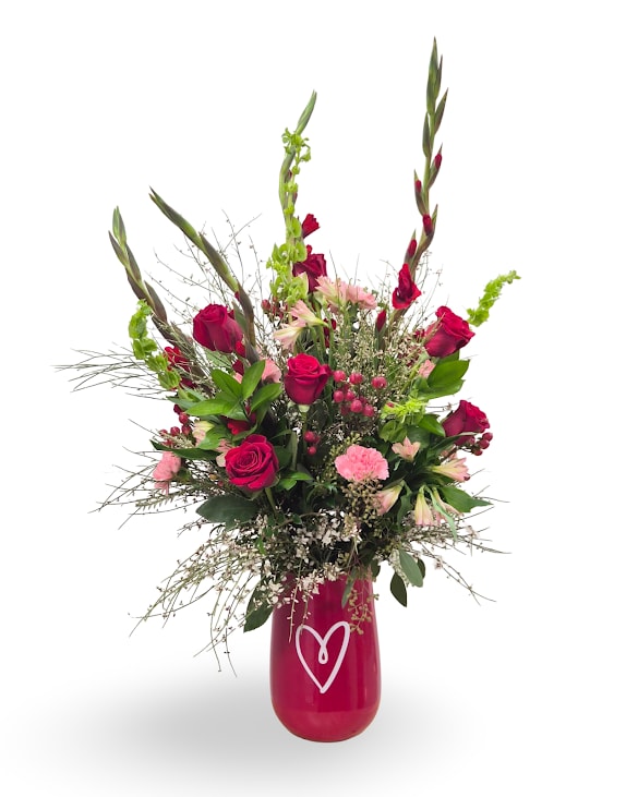 Passionate Love - Passionate Love is a bold, romantic arrangement featuring rich red blooms, soft pink accents, and lush greenery, designed with height and movement for a striking presentation. Arranged in a keepsake vase, this piece makes a dramatic statement of love and admiration. Approximately 37 × 23 × 19 inches.